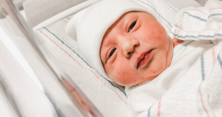 Newborn baby with hat on.