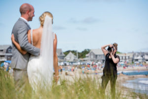 Photographer taking a photo of a newly married couple I Questions to Ask Your Wedding Photographer Blog