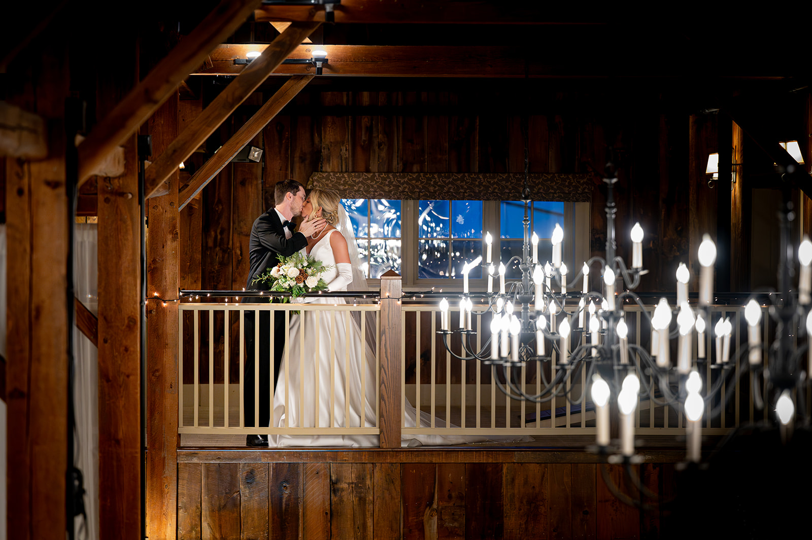 Bride and Groom kissing inside the barn at Gibbet Hill