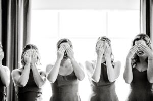 Bridesmaids covering eyes to see bride for the first time