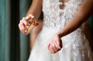 Bride putting on perform on wedding day 
