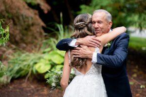 Father of the bride hugging his daughter 