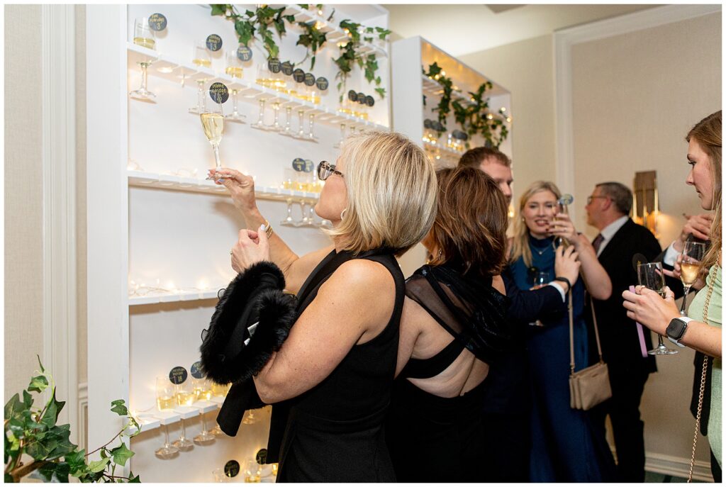 guests take a glass of champagne off the seating chart display at the Newport Marriott Hotel Wedding reception 