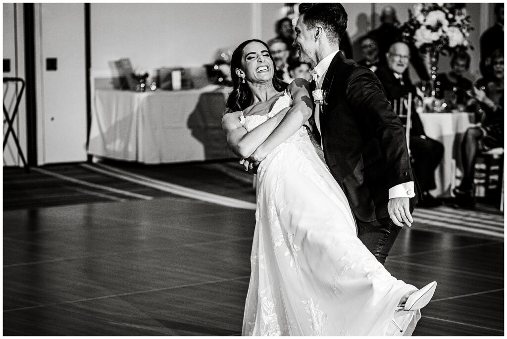 groom dips the bride during their first dance 