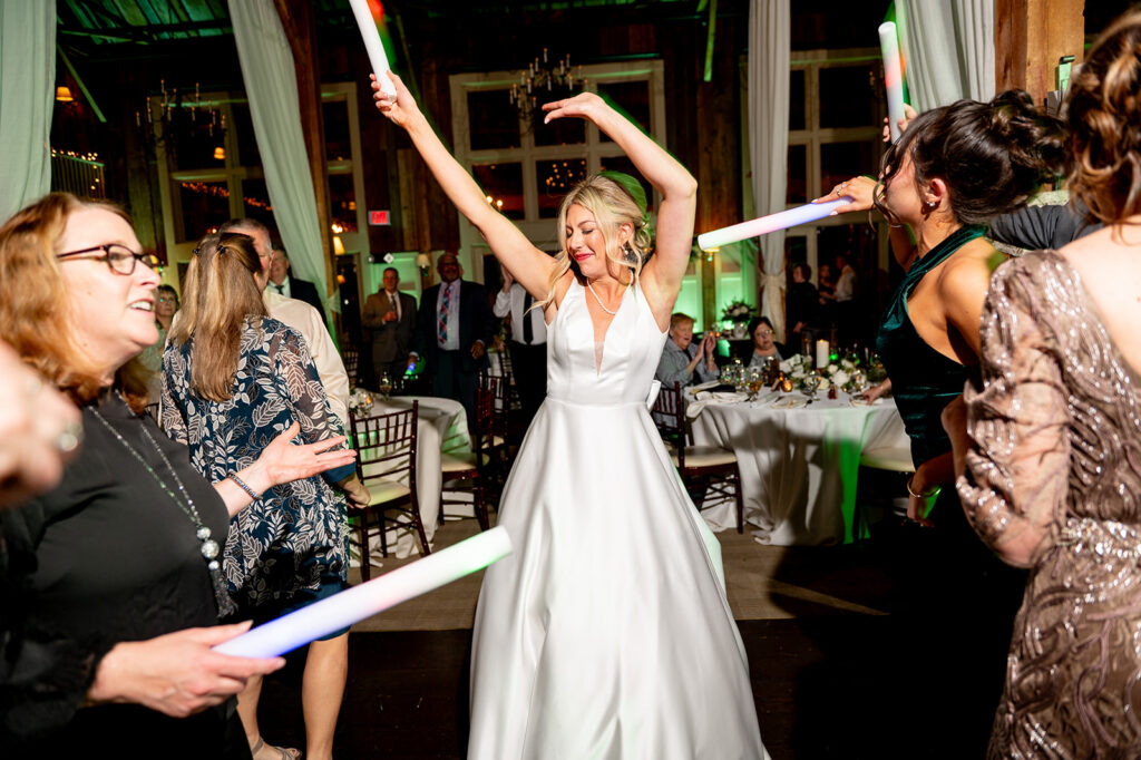 bride dances with her guests at the wedding reception 