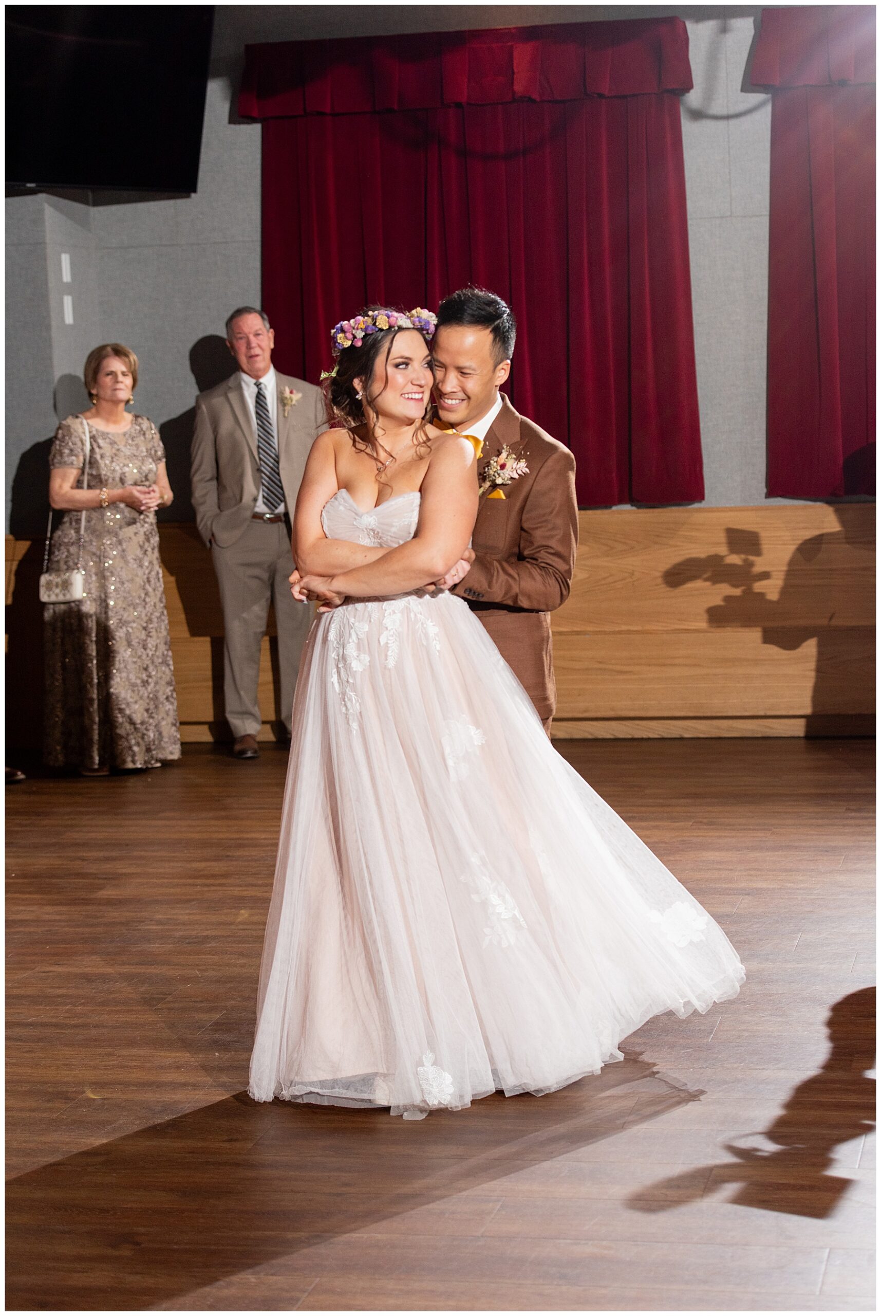 bride and groom smile at each other during their first dance 
