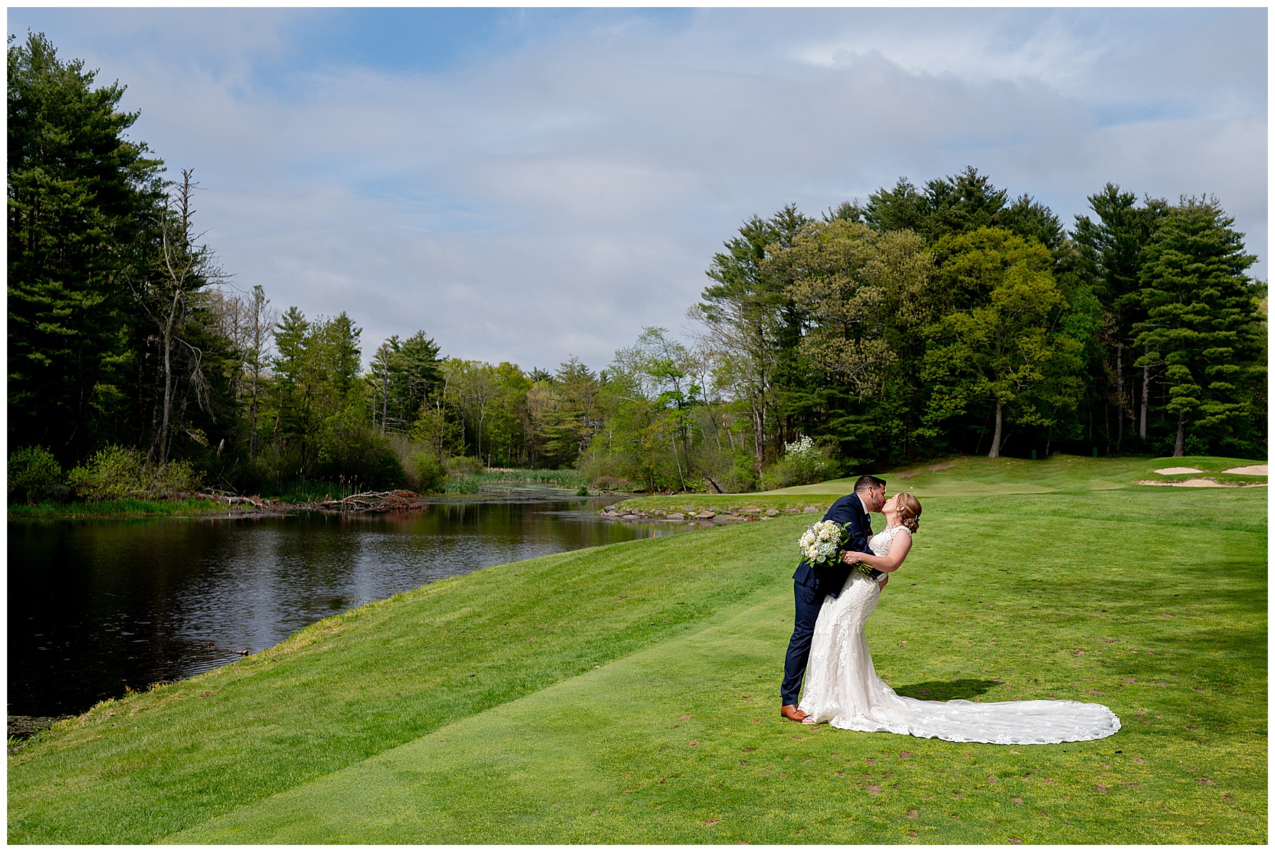 bride and groom kiss with the backdrop of the sunny golf course 