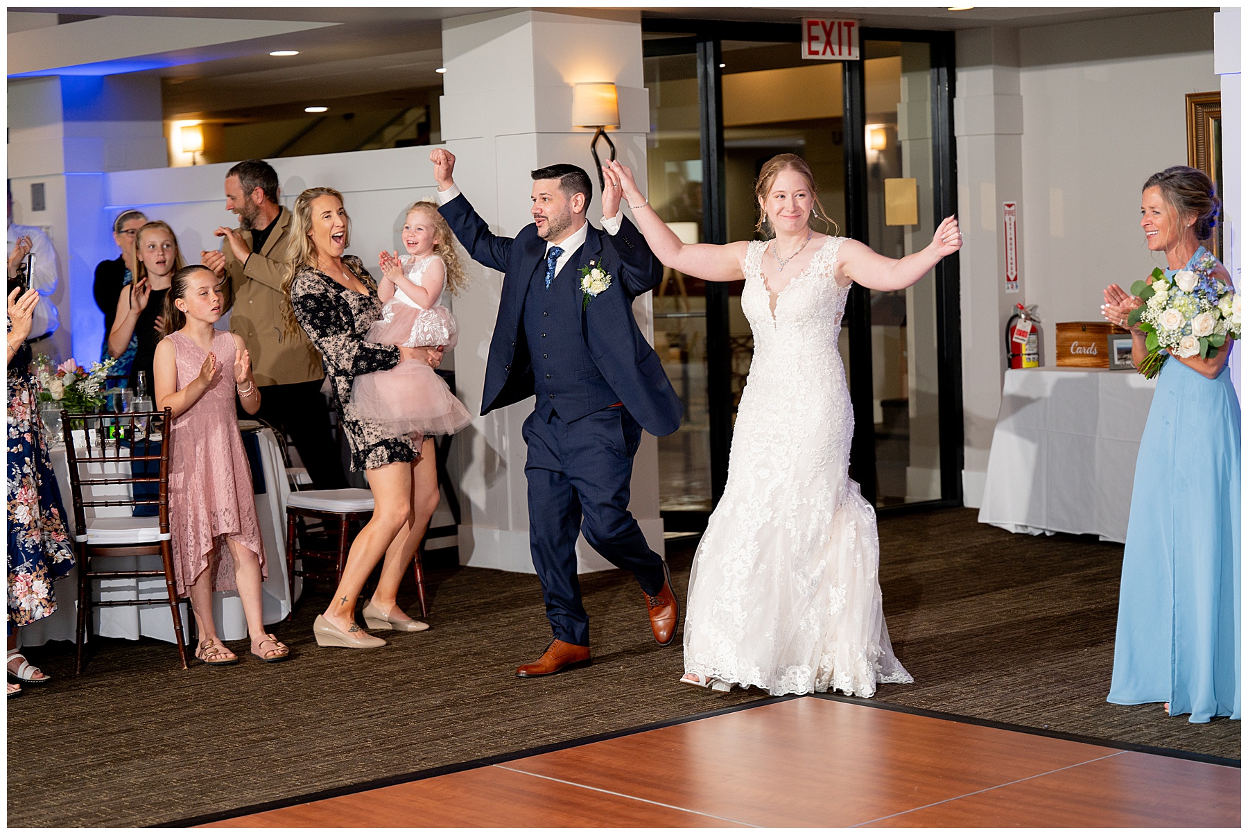 the bride and groom enter their reception celebrating