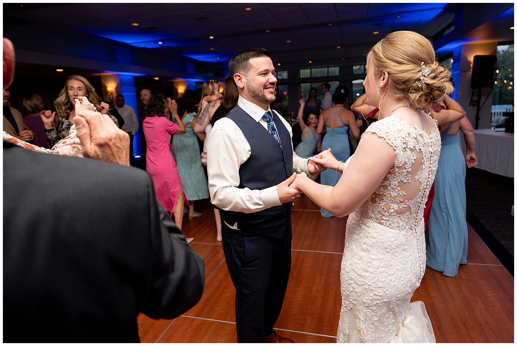 the bride and groom on the dance floor with their guests