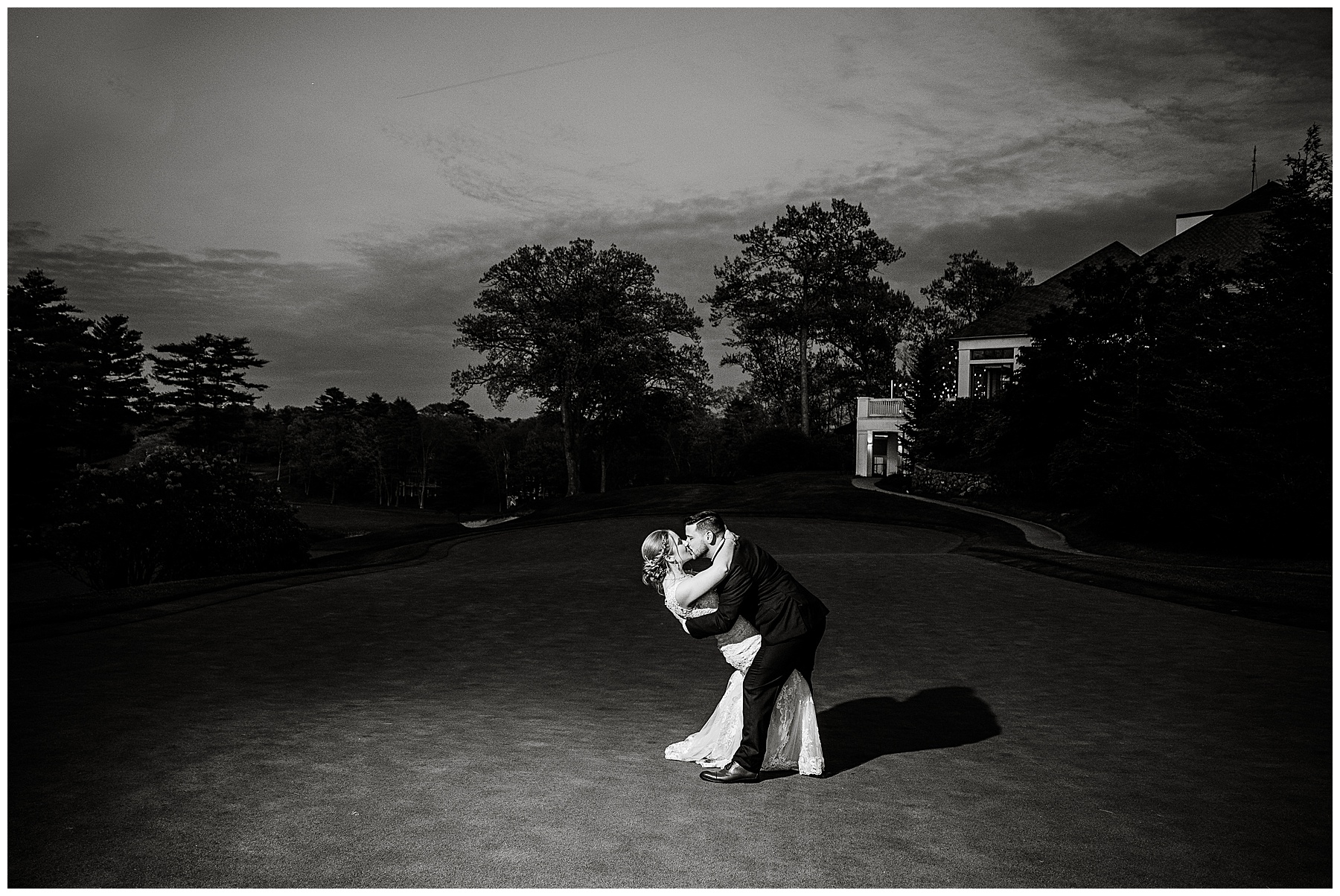 a black and white photo of the bride & groom kissing at nighttime on the golf course in Ipswich, Massachusetts