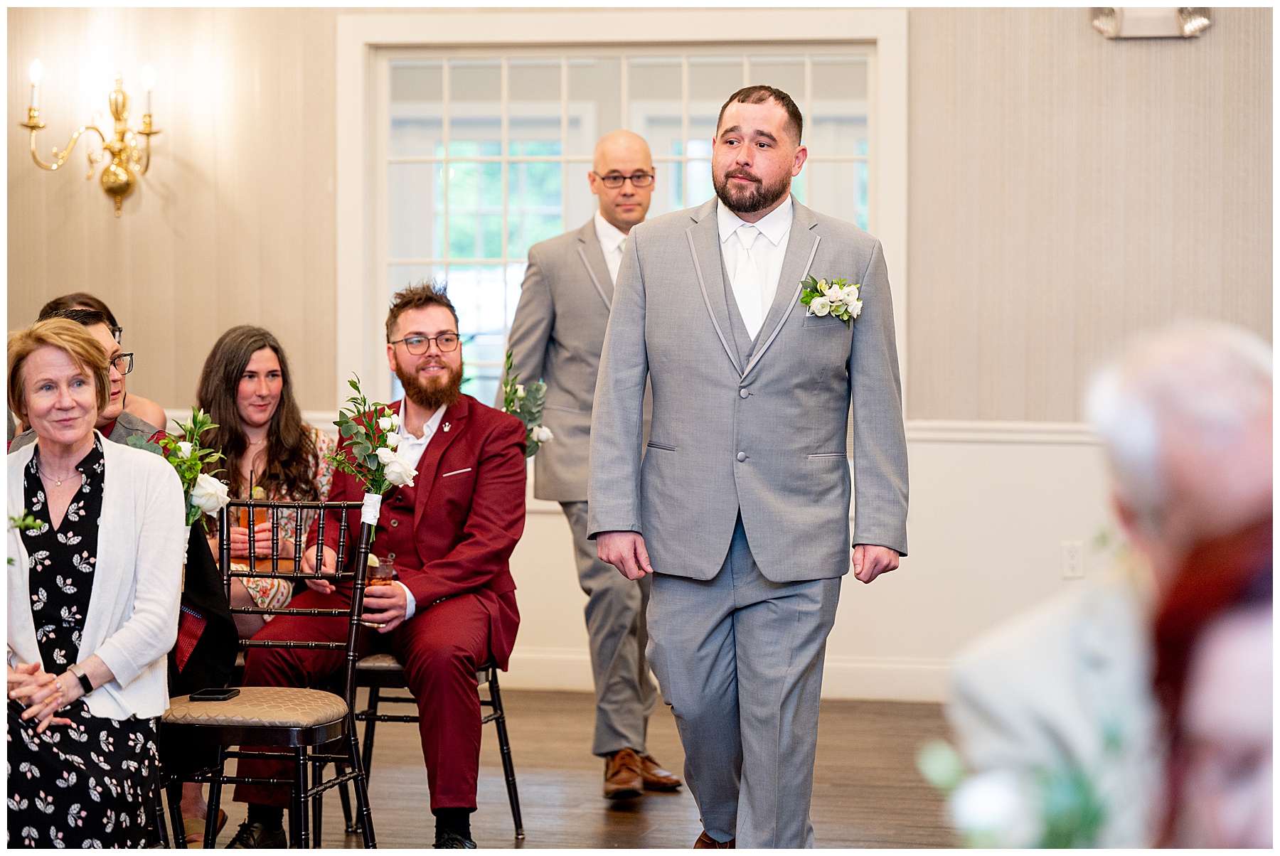 Groom walking down the aisle at an inside wedding ceremony at the Chocksett Inn