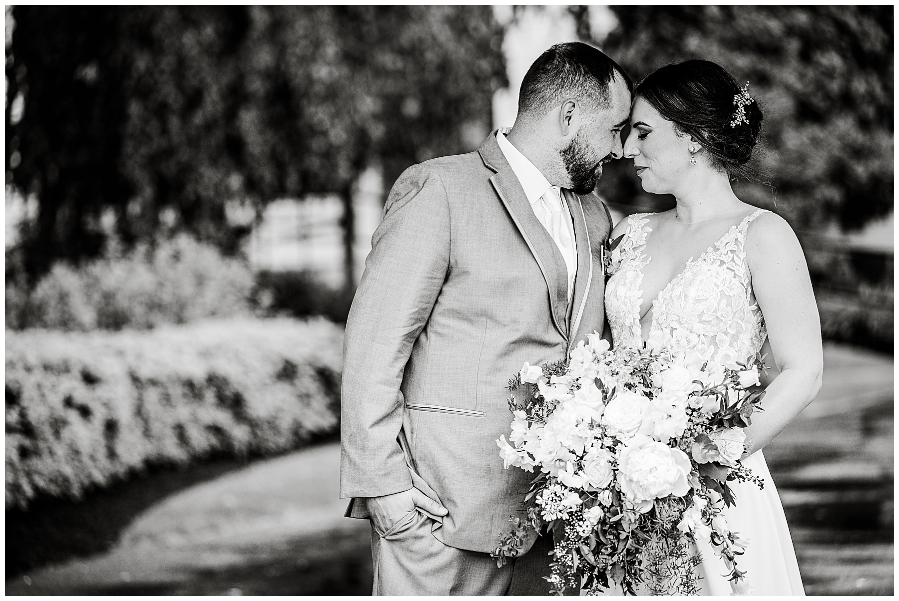 black and white photo of the bride and groom embracing 