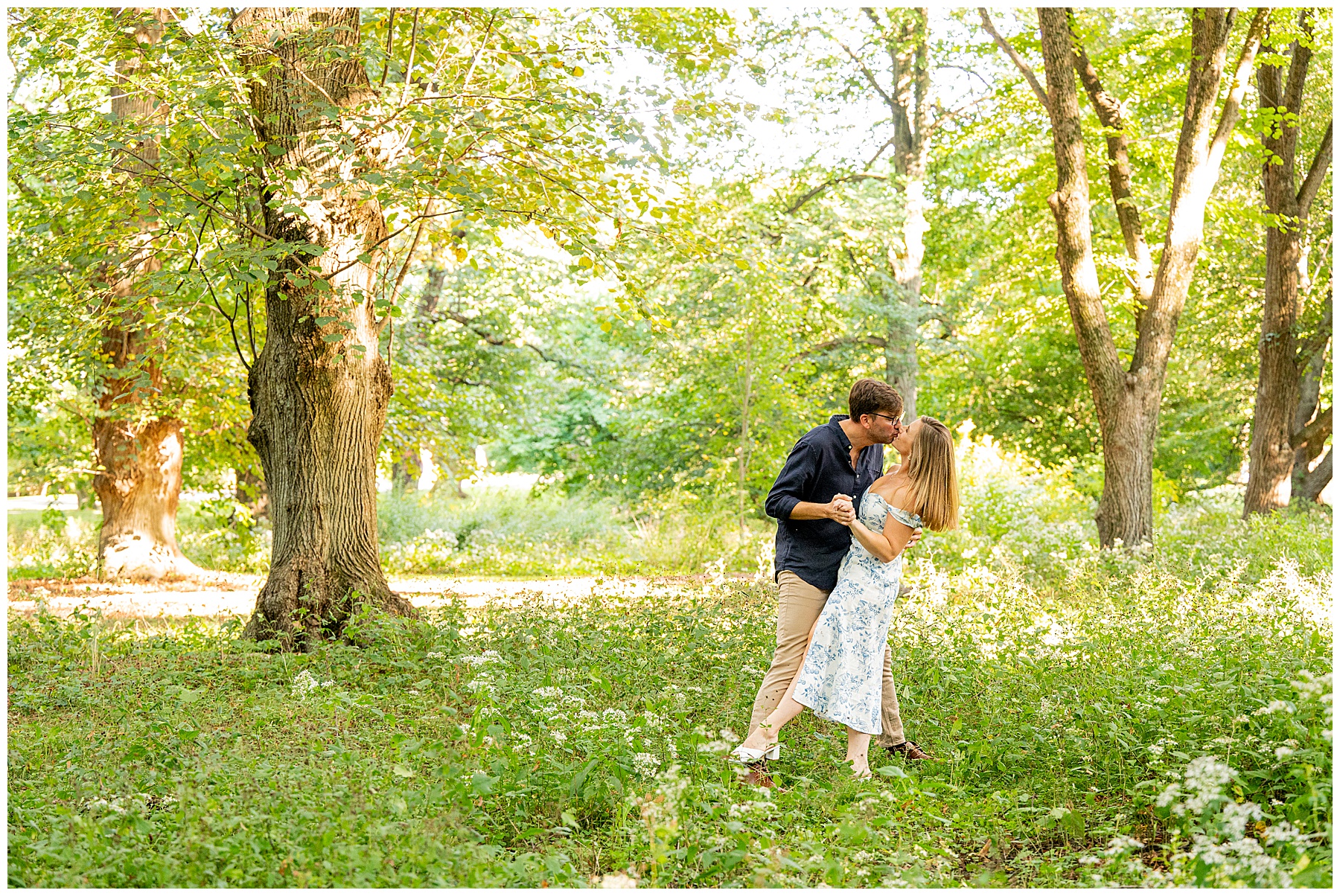 man and woman kissing during their Engagement Session at Arnold Arboretum surrounded by greenery