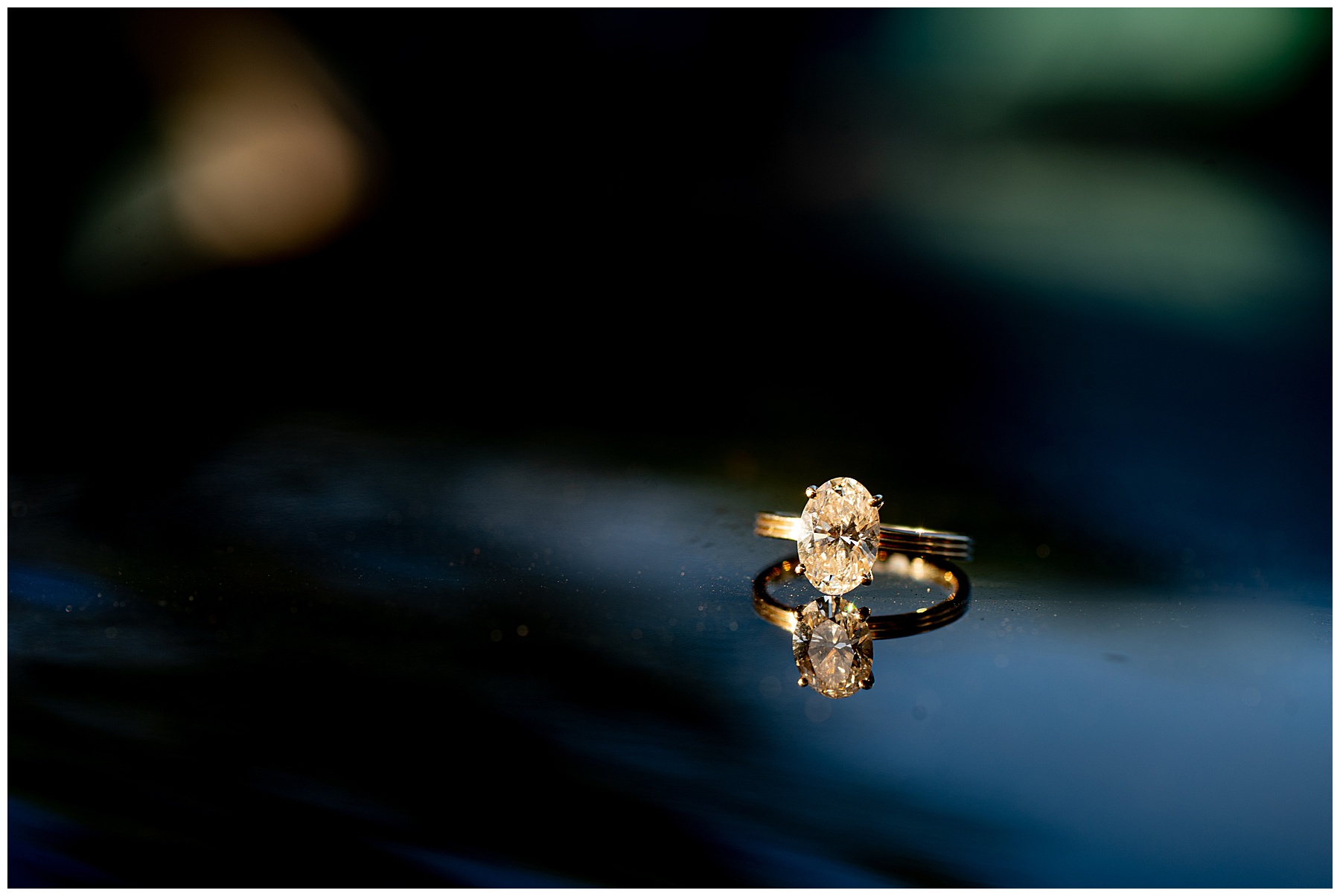 diamond ring sitting on glass table