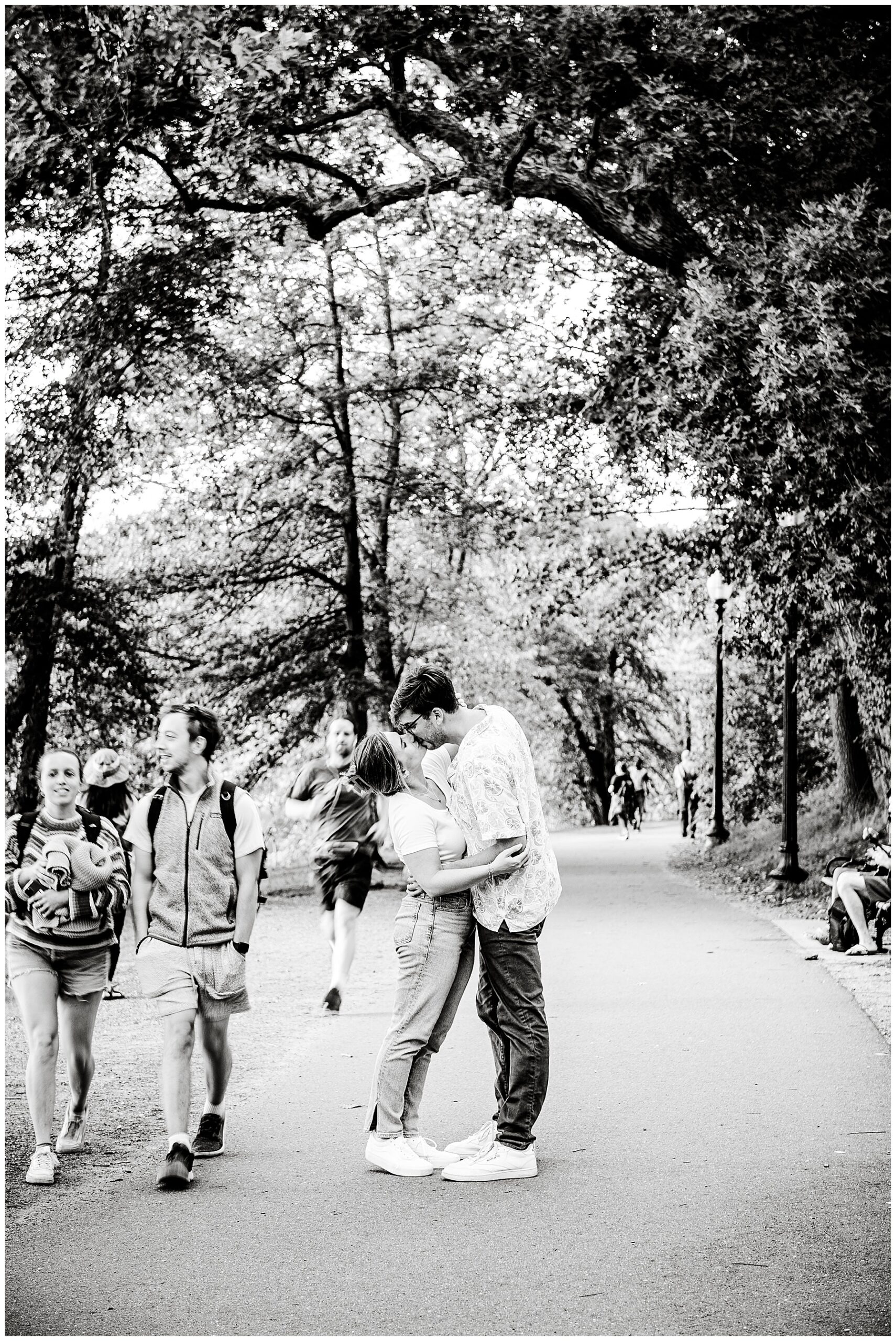 black and white photo of the happy couple kissing along a pathway at their boston engagement session