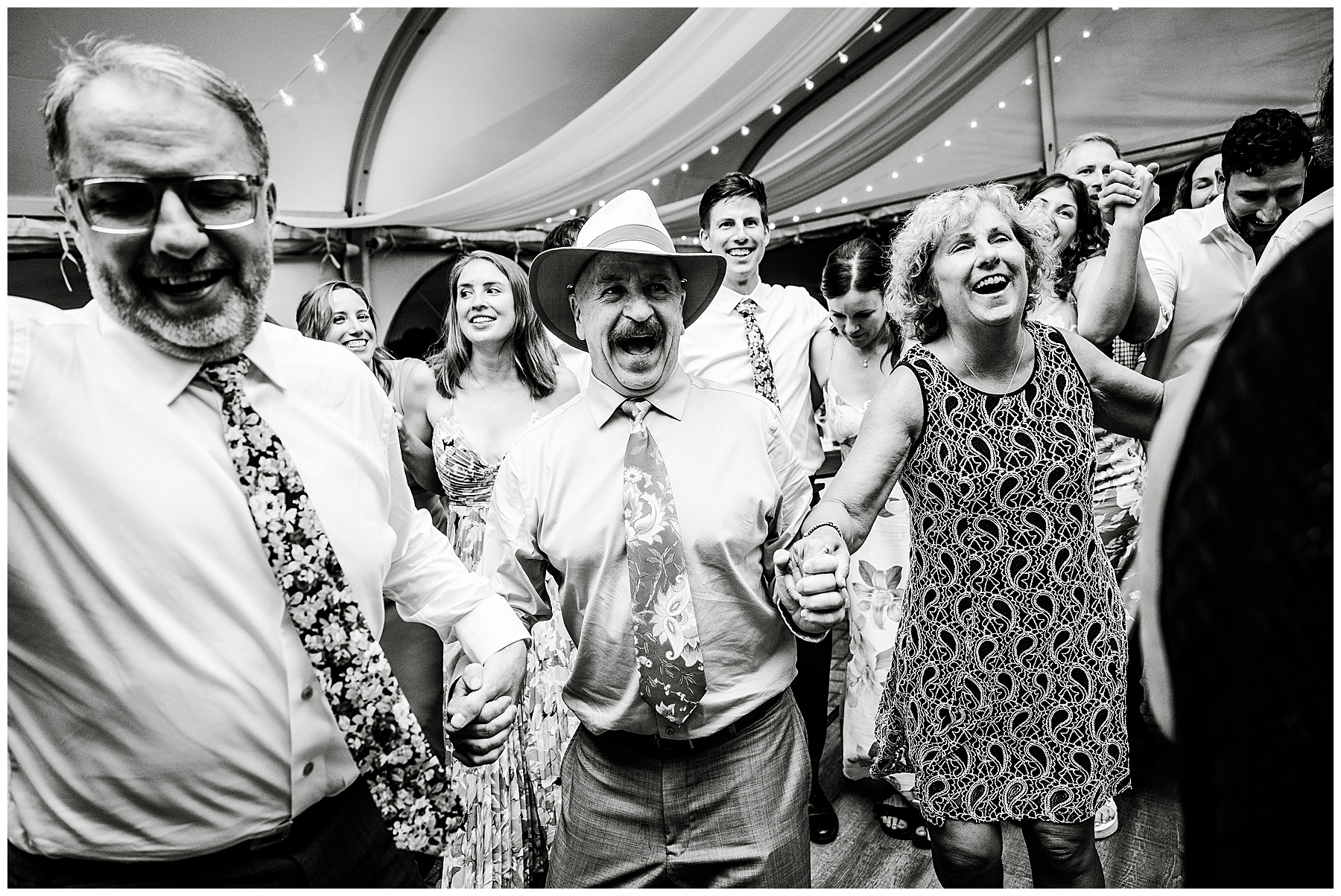 black and white photo of guests dancing during the wedding reception