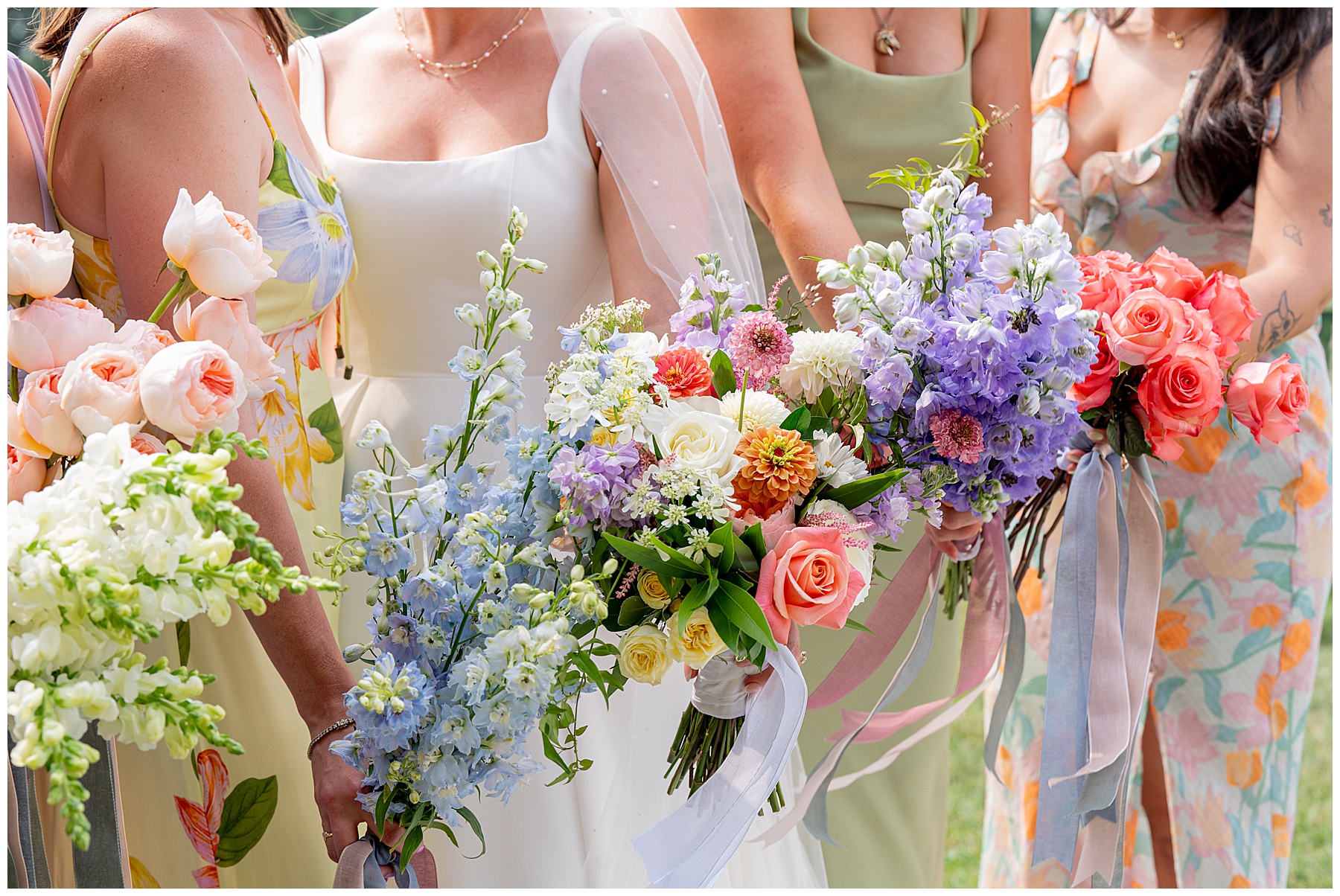 close up photo of bridesmaids bouquets full of colorful wildflowers 