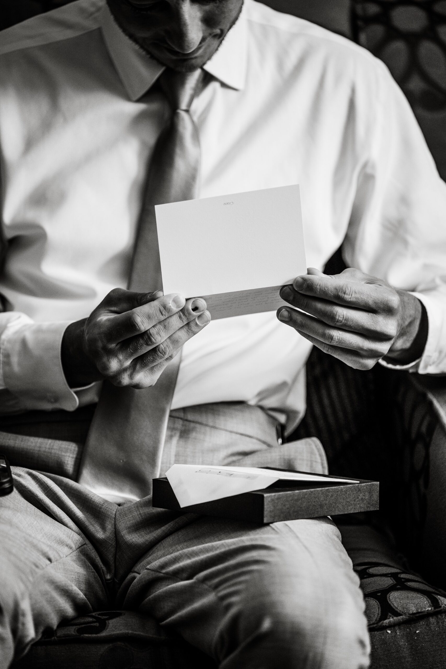 groom holding note card