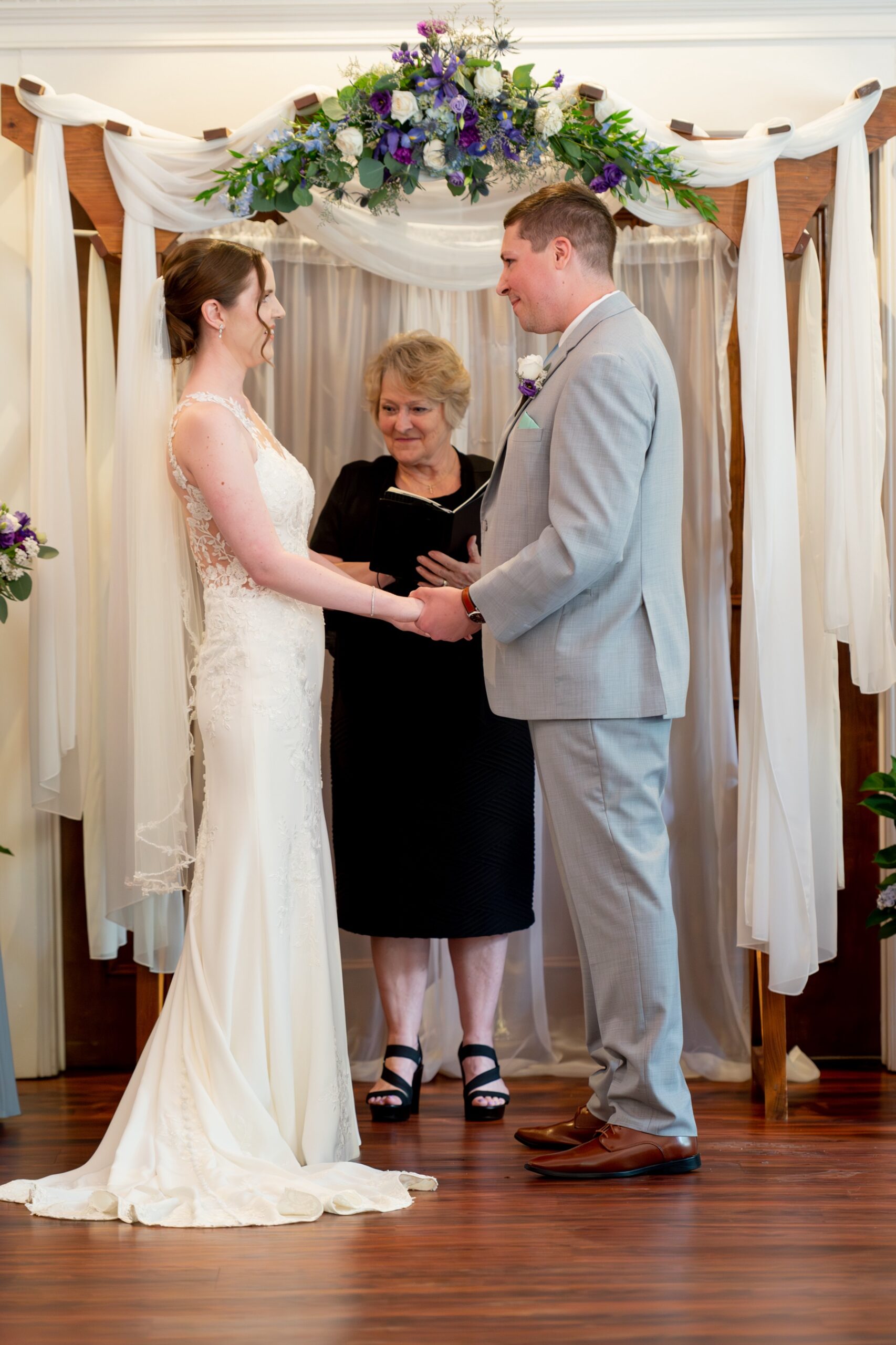 bride and groom standing at the altar holding hands 