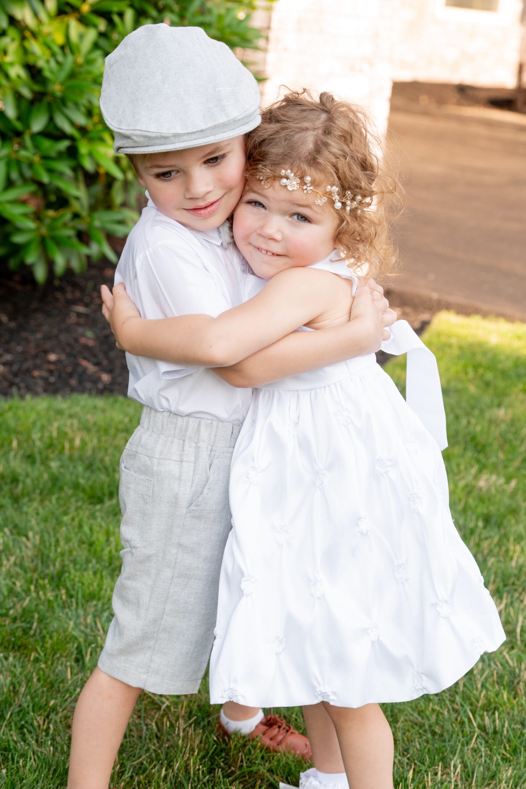 flower girl and ring bearer hugging