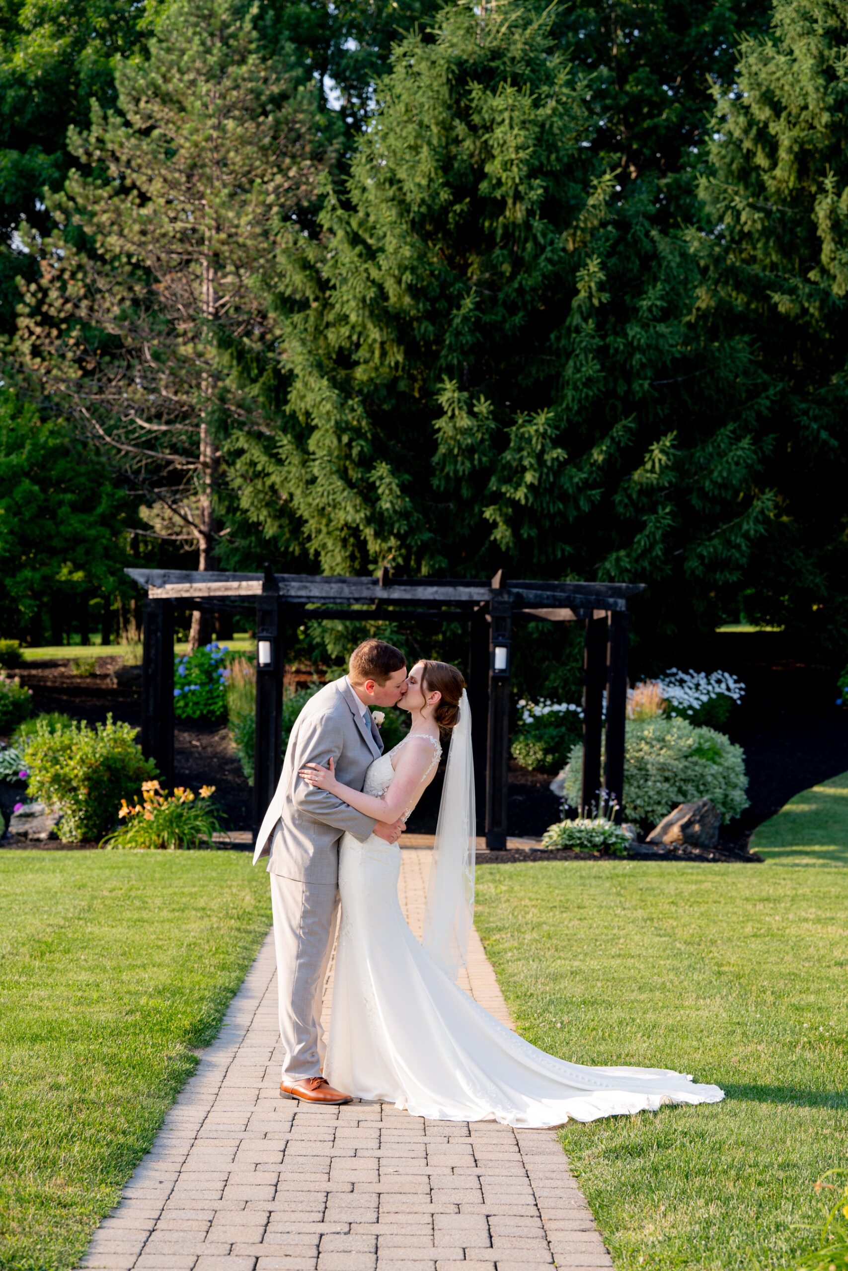 bride and groom kissing outside after their wedding ceremony