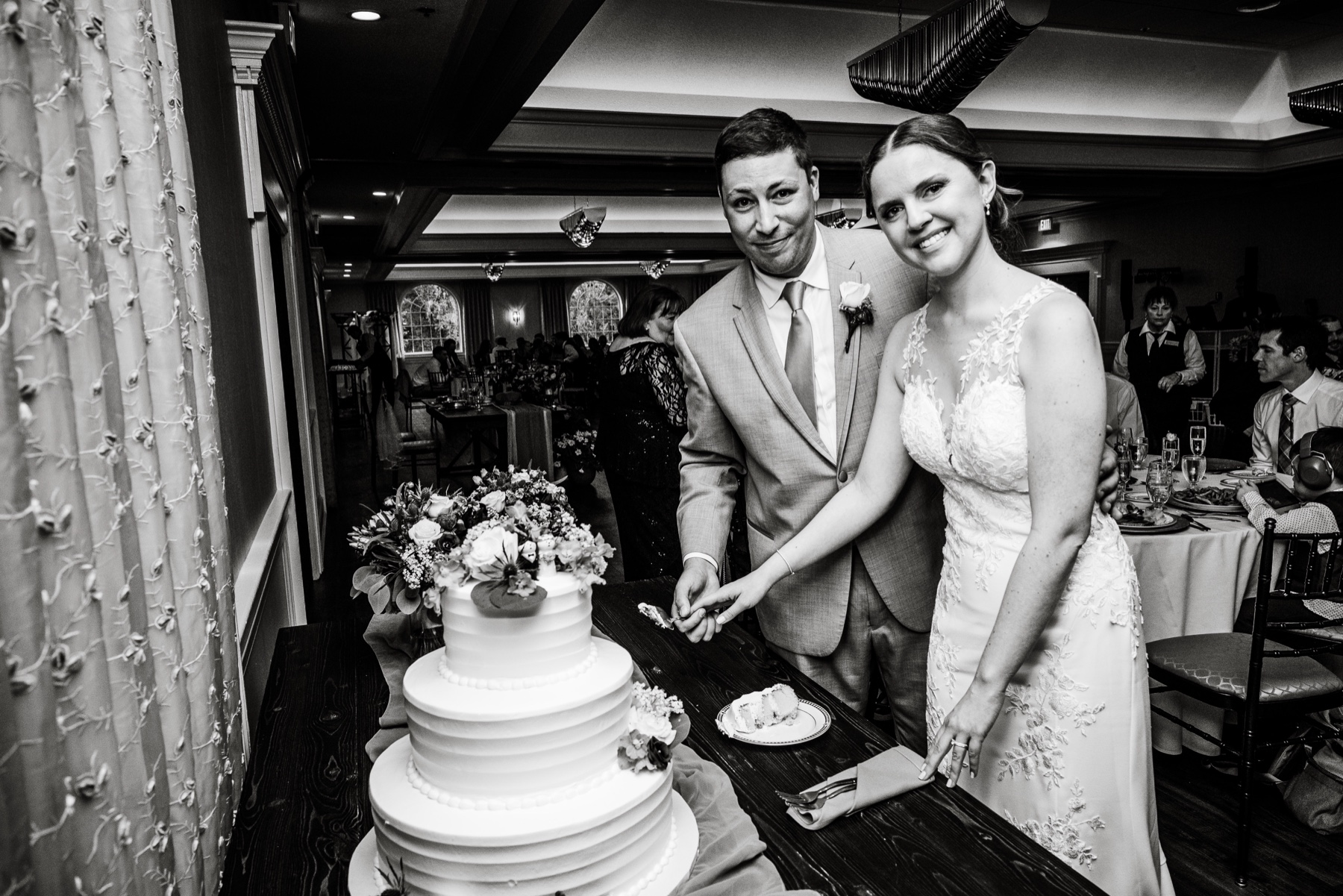 bride and groom cutting cake