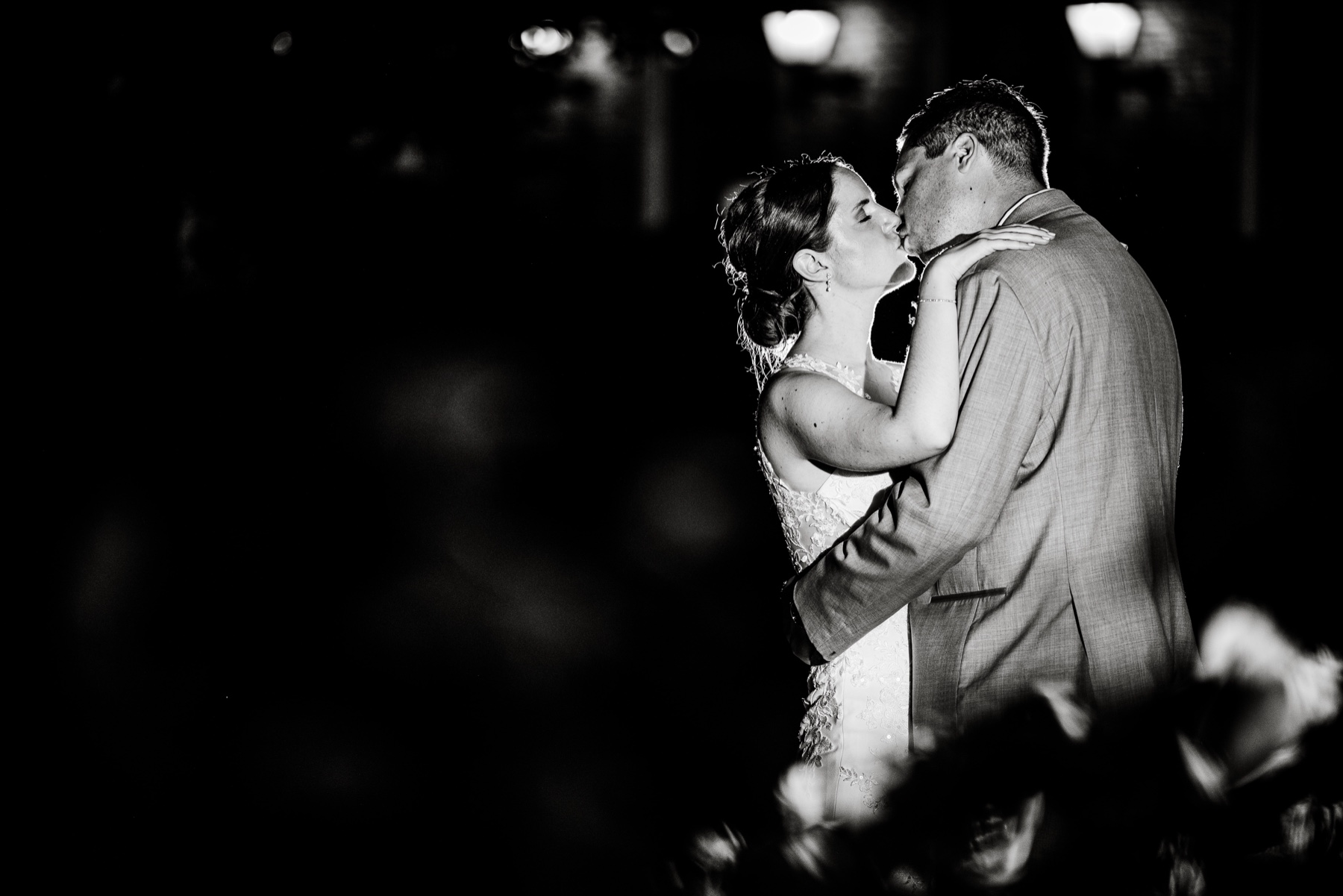 bride and groom kissing in the evening during their wedding reception 