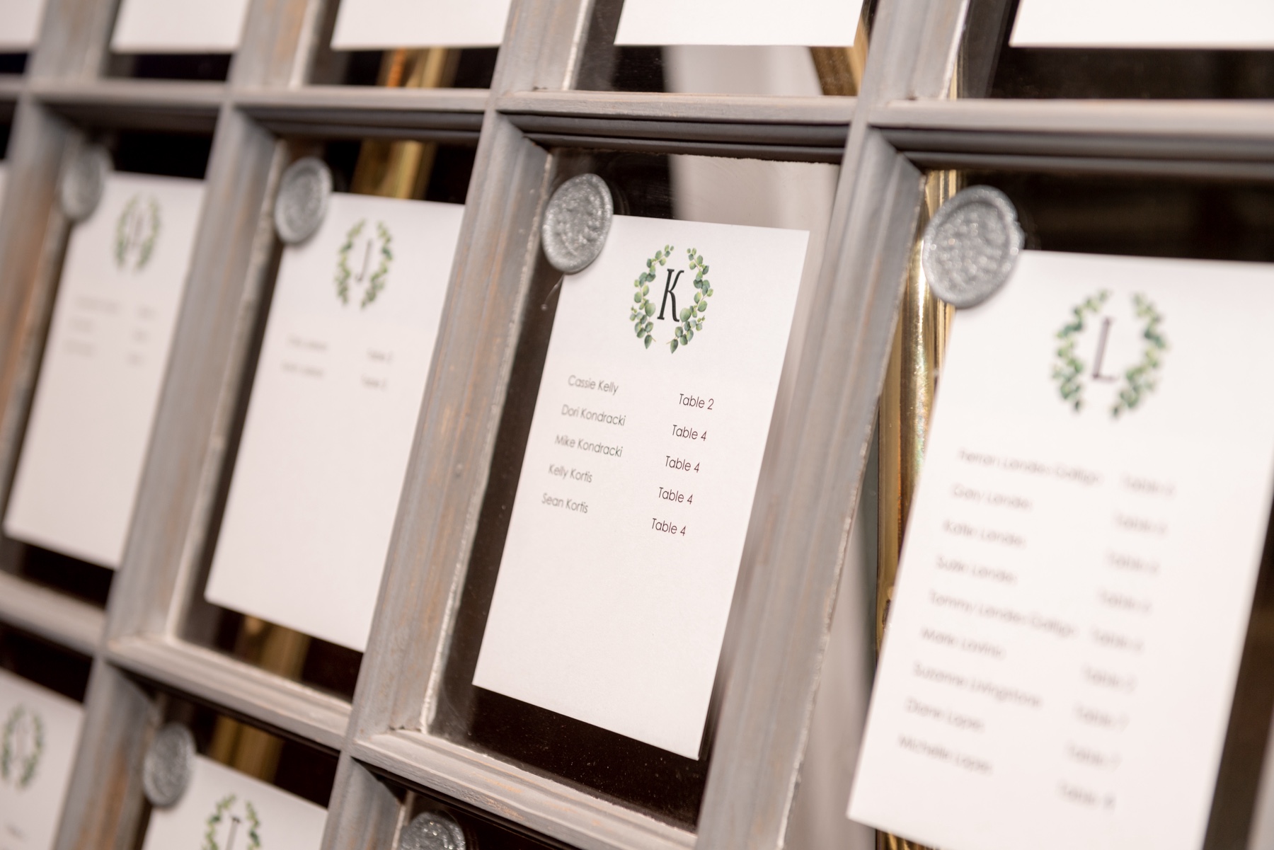 white seating charts with grey wax seals