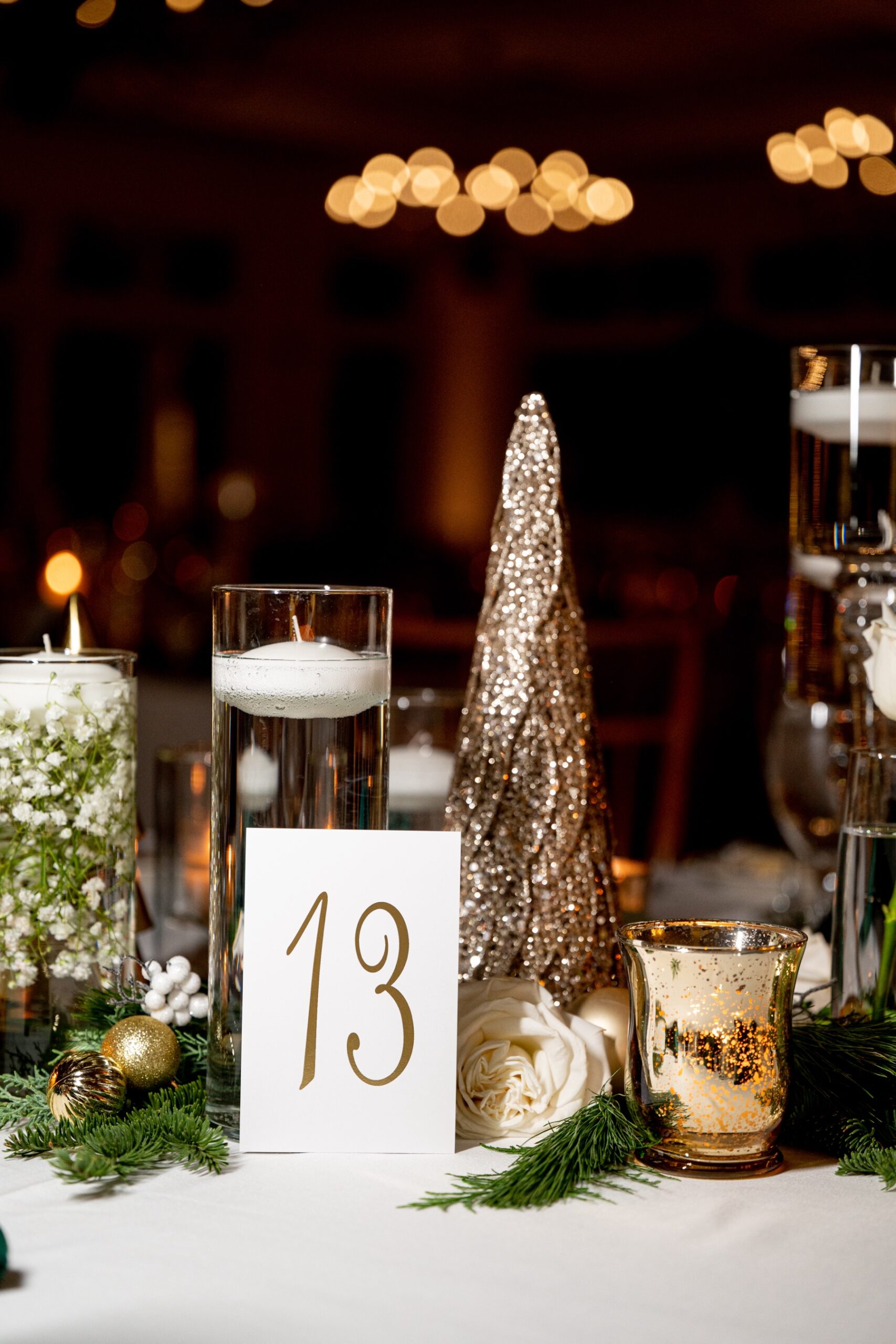 wedding reception decor of gold christmas wedding tree and white candles