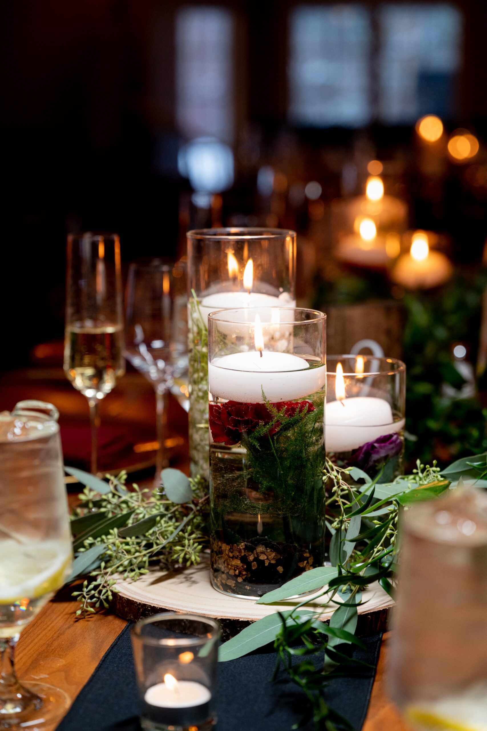 wedding decor of candles and greenery 