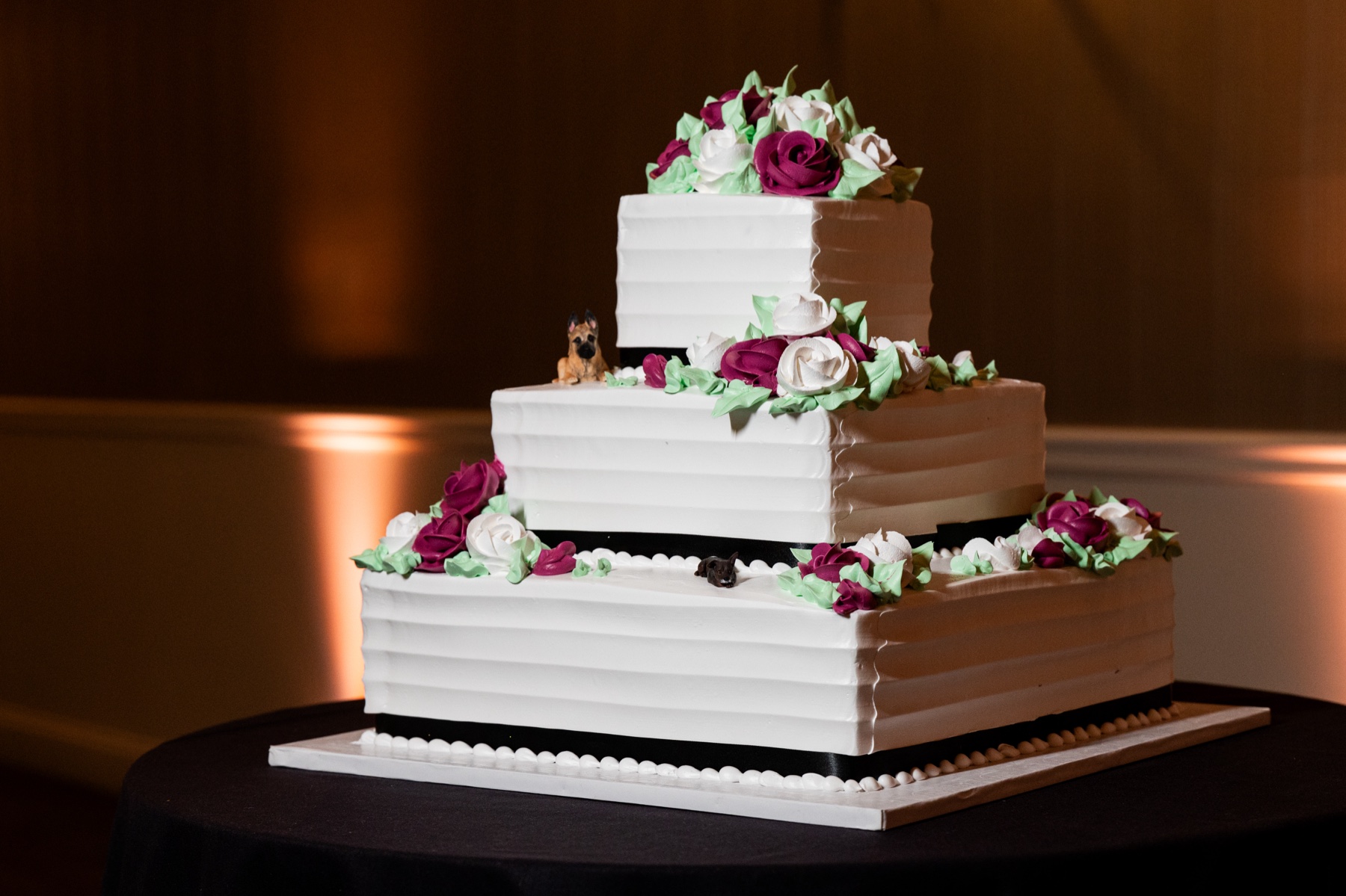 white wedding cake with green and pink frosting flowers 