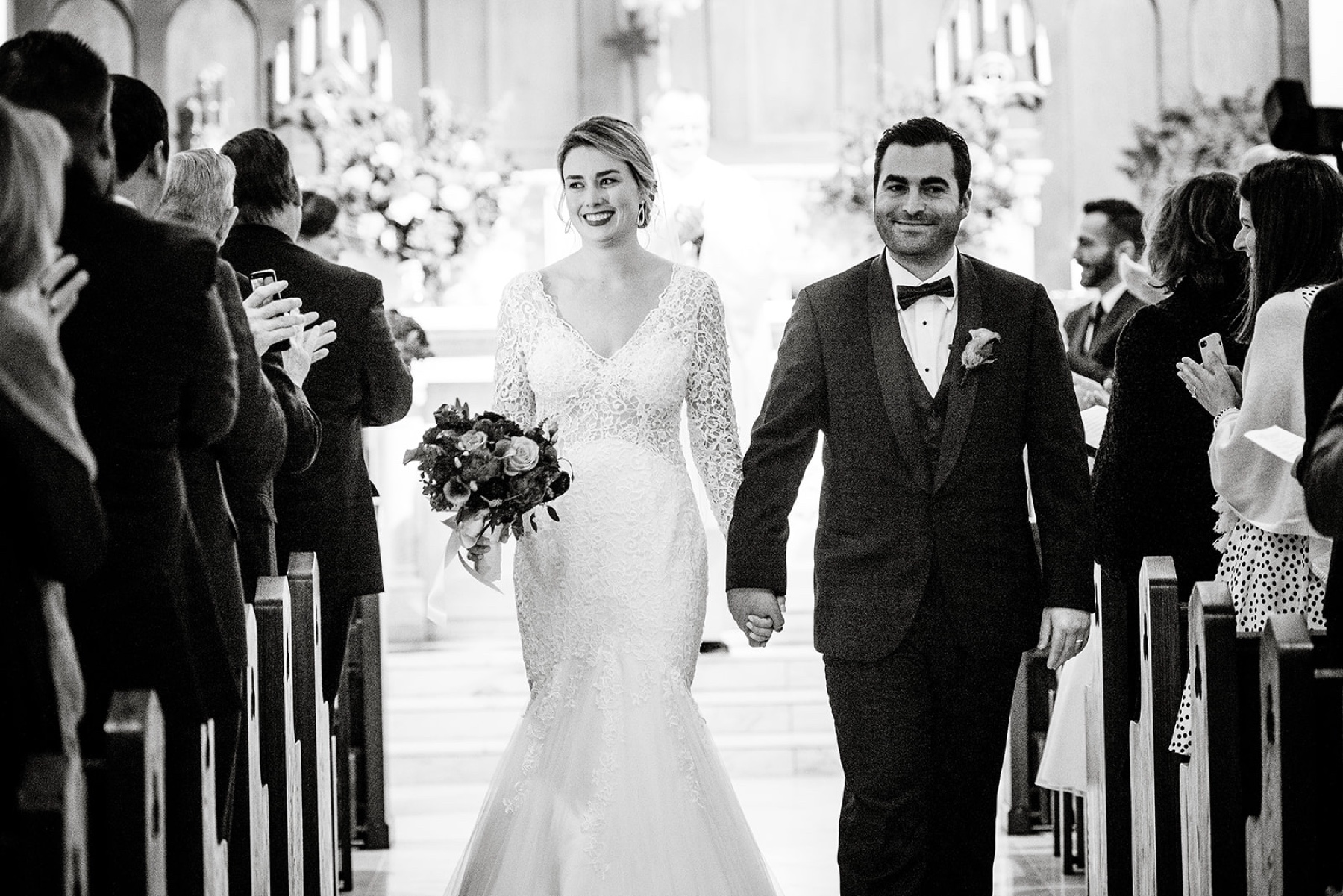 bride and groom walking up the church aisle after their Winter Wonderland Wedding ceremony 