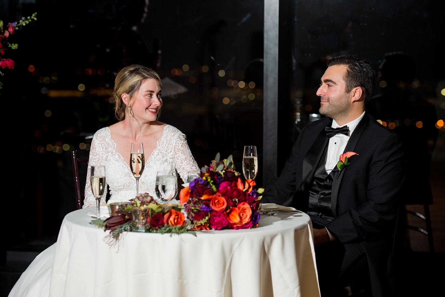 bride and groom sitting at their reception table for their Winter Wonderland Wedding 