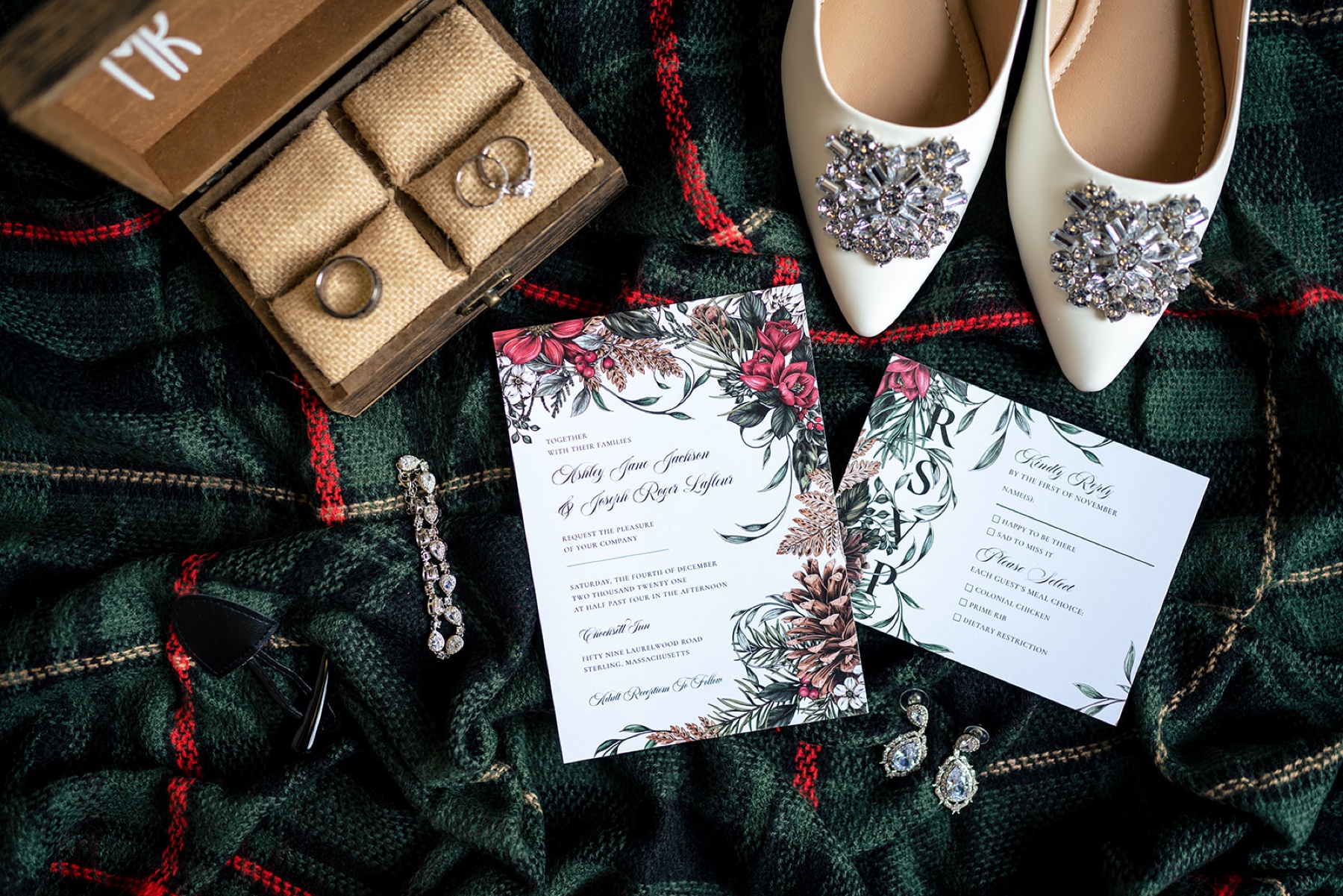 red and green wedding invitations with a plaid blanket underneath 