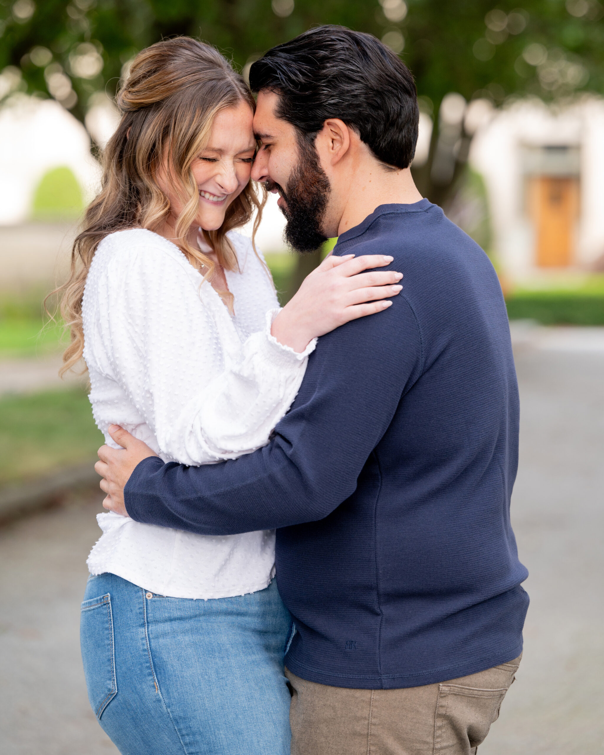 couple hugging and laughing during their engagement session