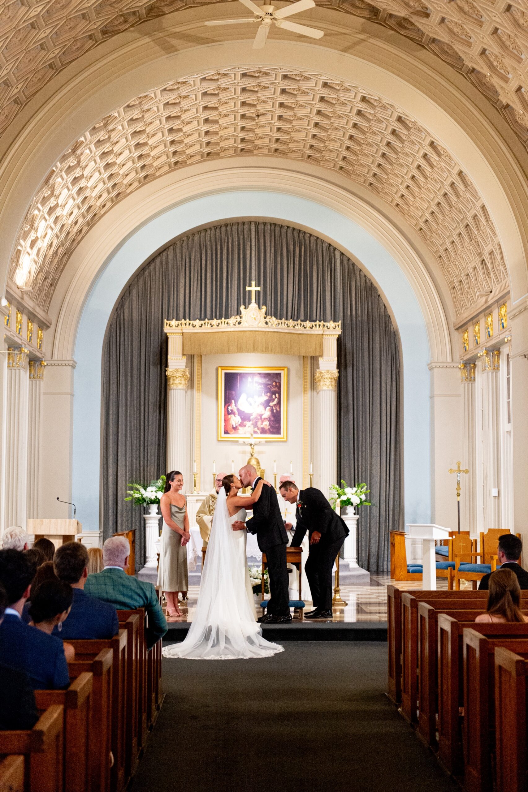 bride and groom kiss at the end of the aisle after the wedding ceremony 