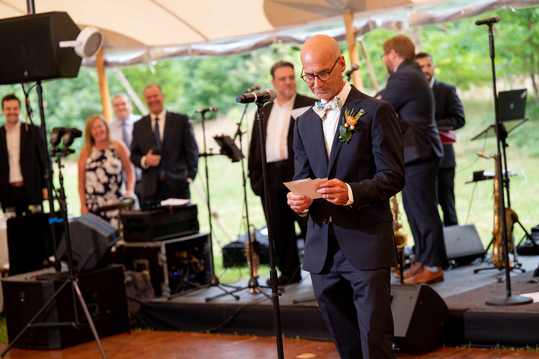 father of the bride standing at the microphone giving a toast 