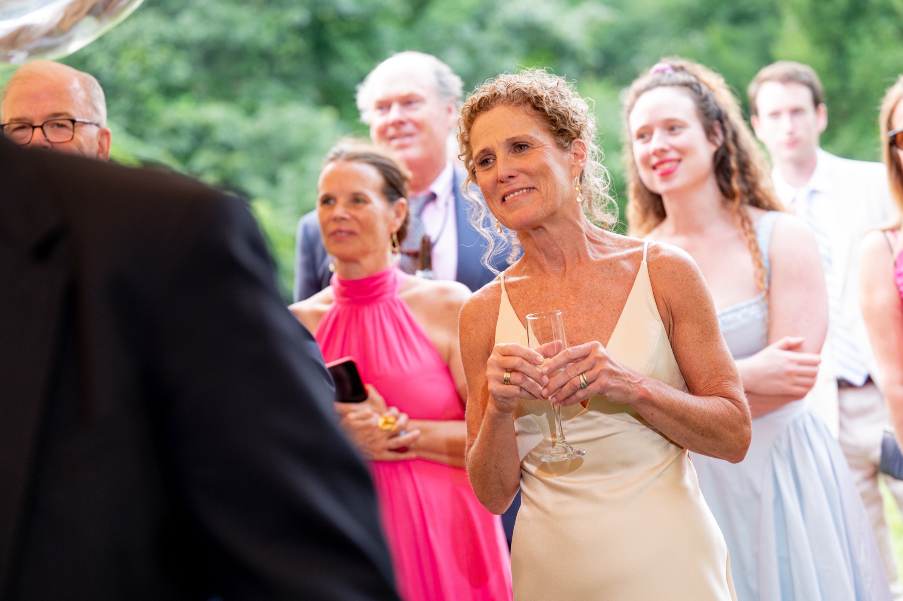 mother of the bride looks on as father of the bride gives his wedding toast 