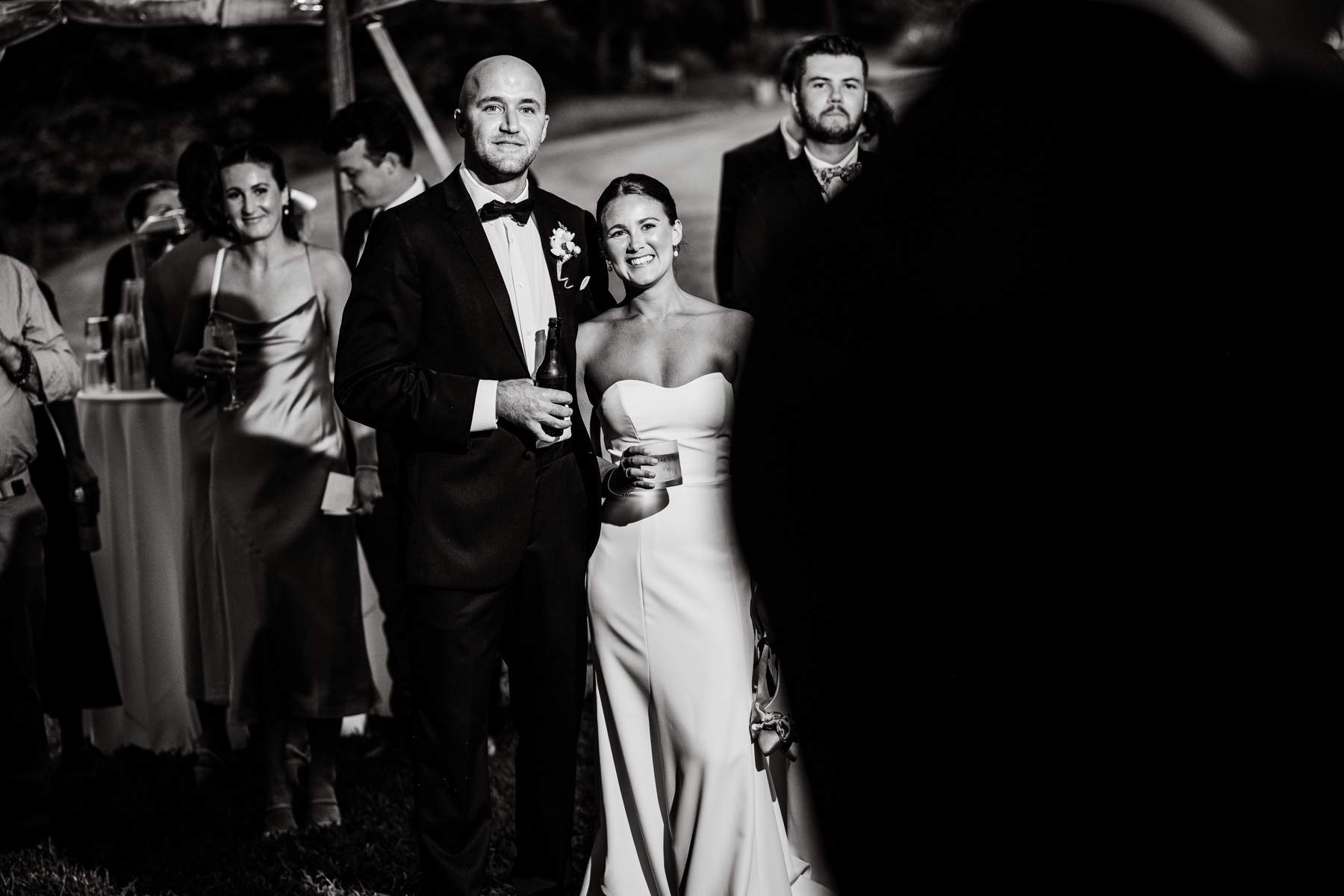 bride and groom listening on to best man speech at wedding reception 