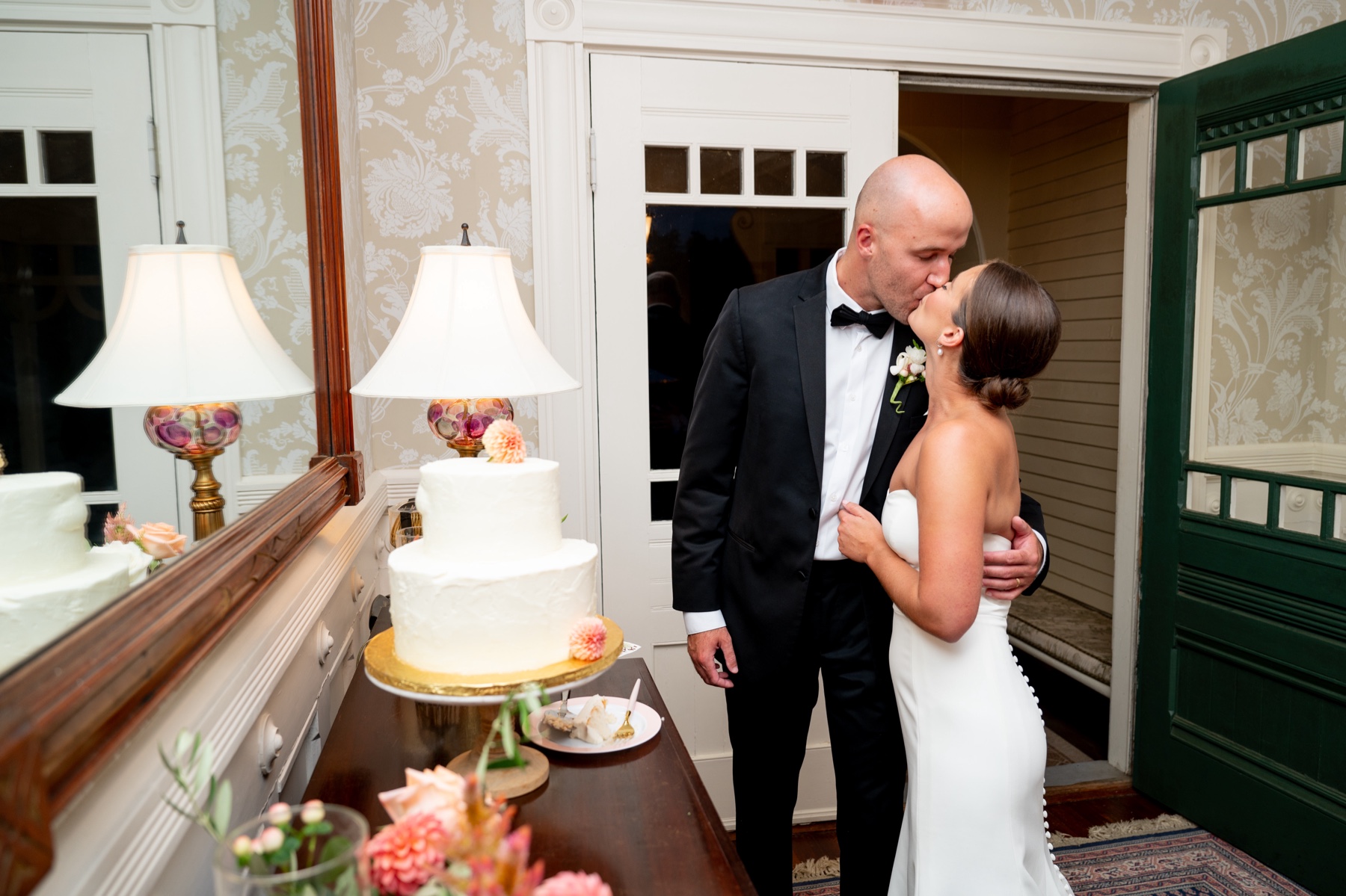 bride and groom kissing after the cake cutting for their Elegant South Shore Summer Wedding