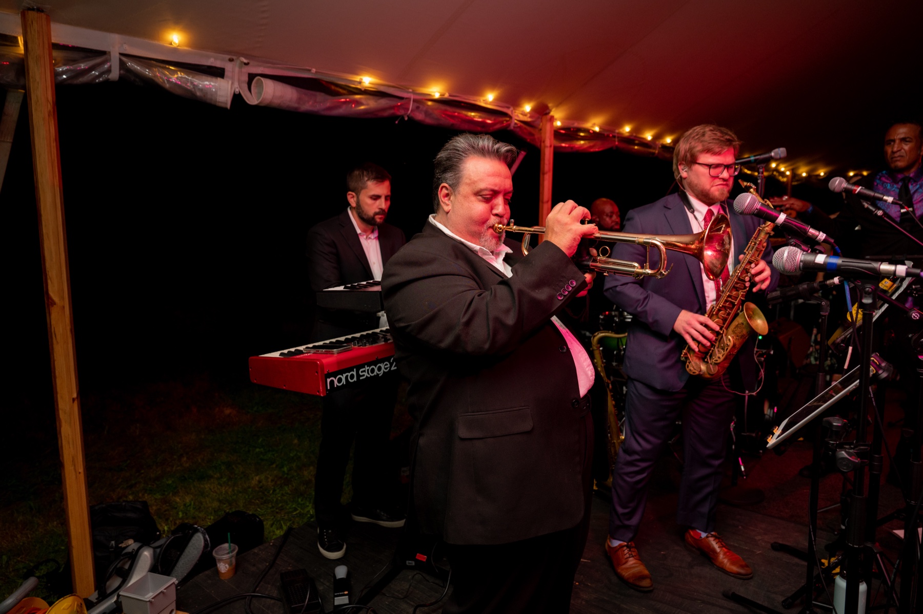 live band playing trumpet and saxophone during the wedding reception 