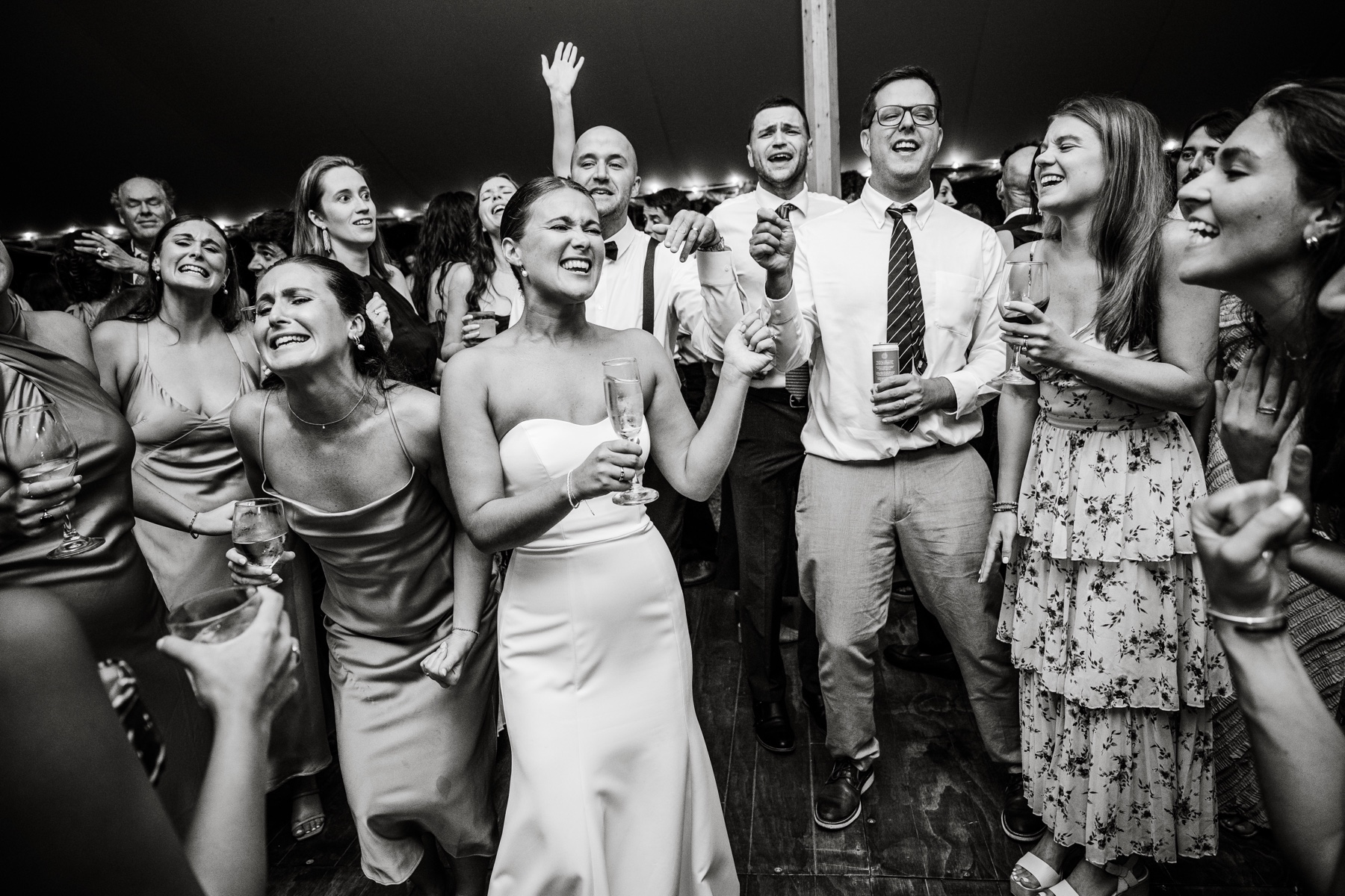 bride and bridesmaids singing along on the dance floor with guests 