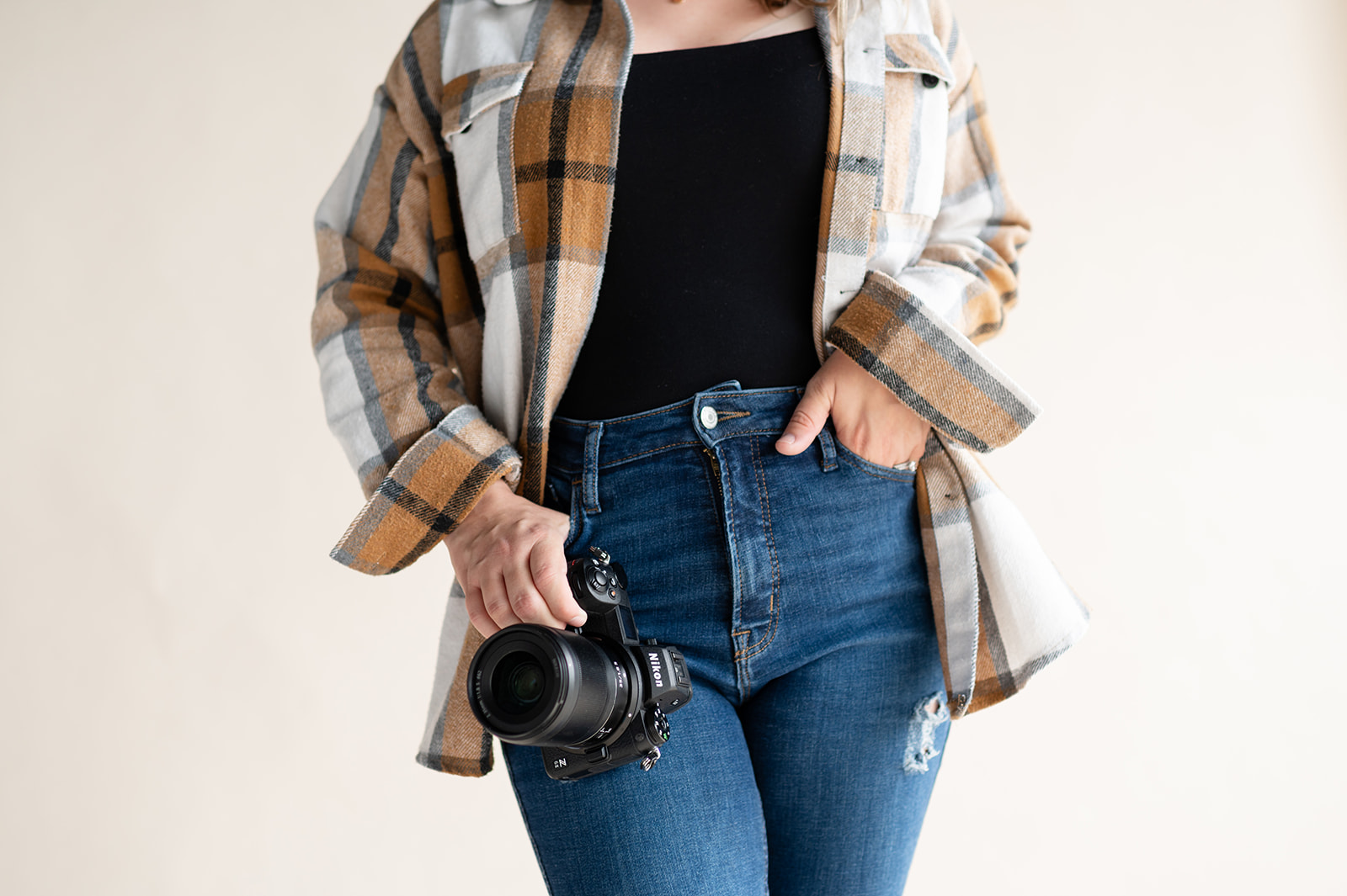 photographer holding nikon camera 