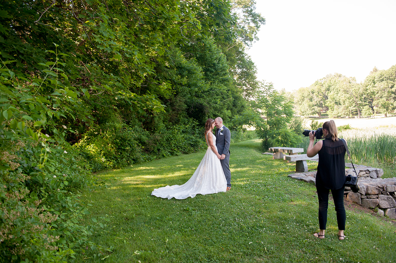 photographer taking photo of bride and groom