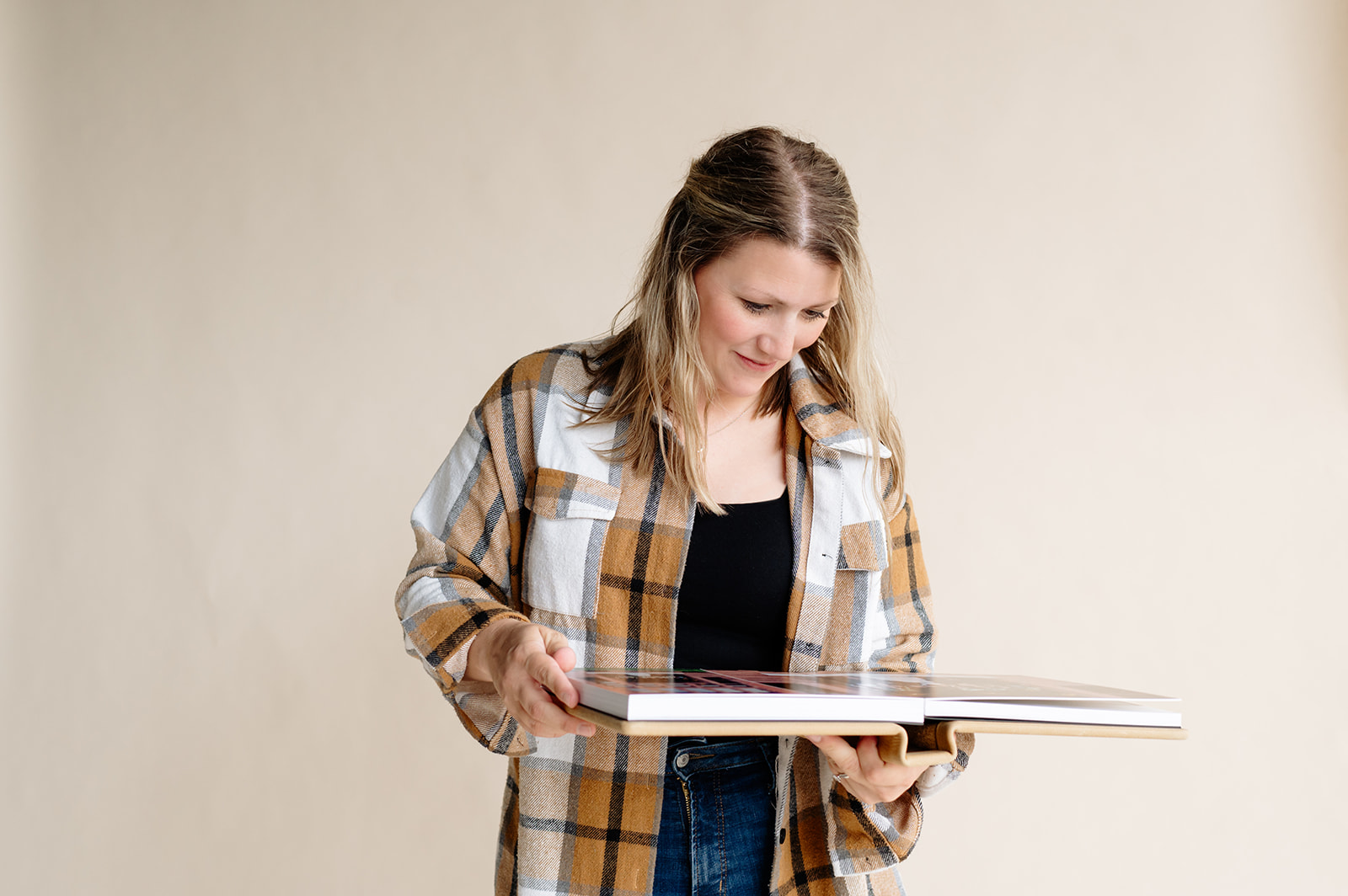 a wedding photographer observing her photo album 