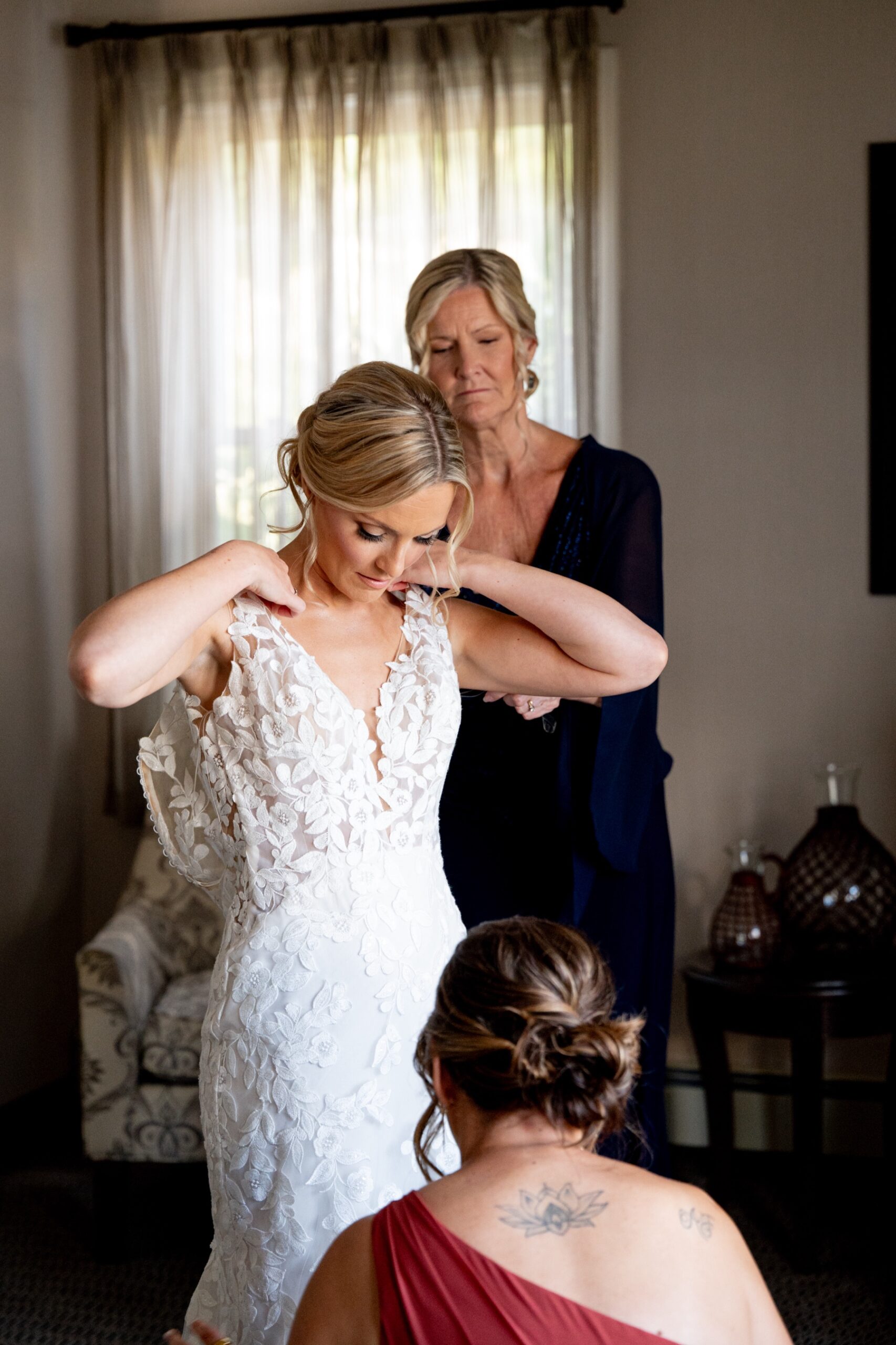 bride getting into her dress for her chocksett inn wedding 