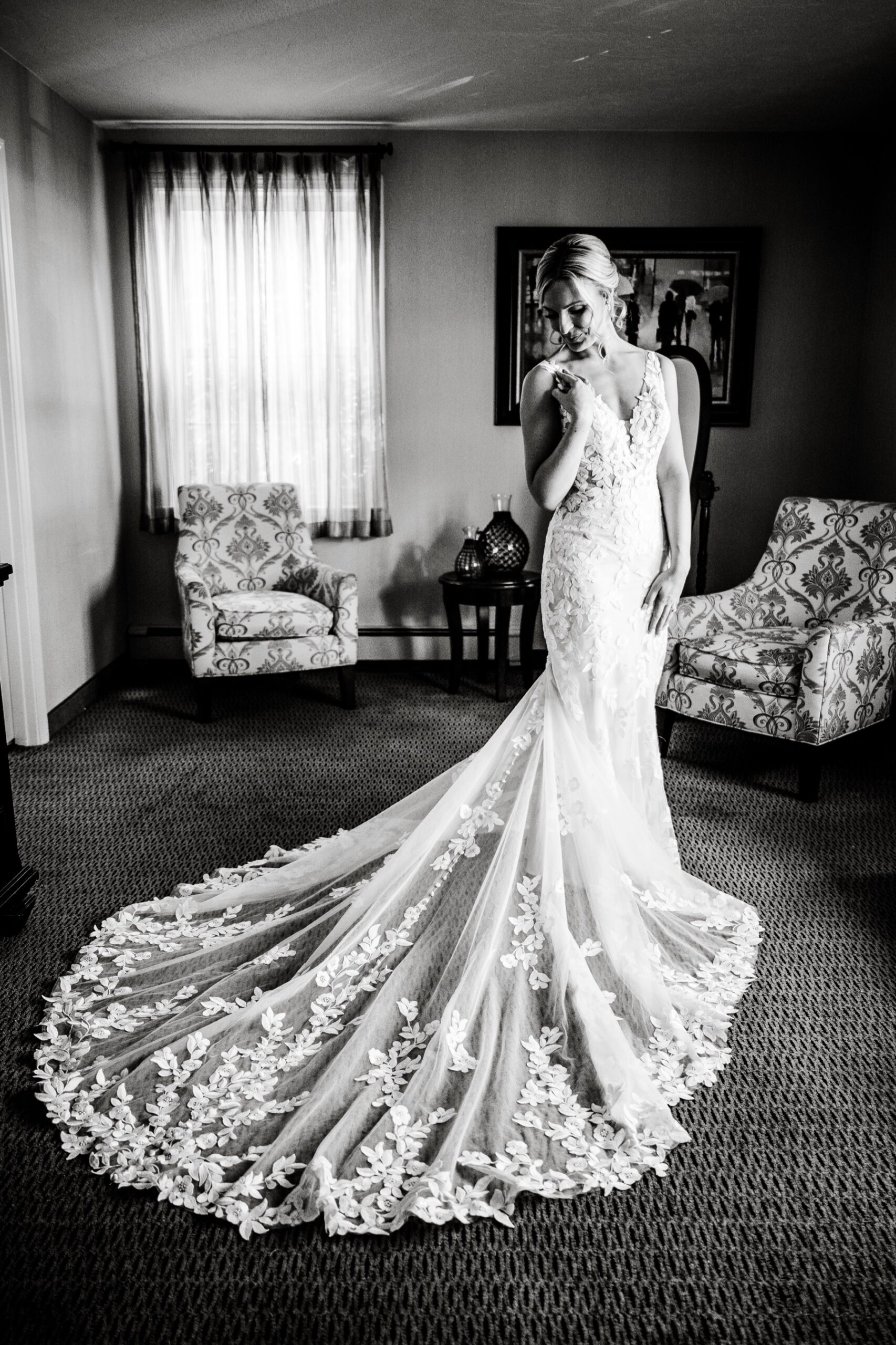 bride standing in her lace wedding dress with a small train