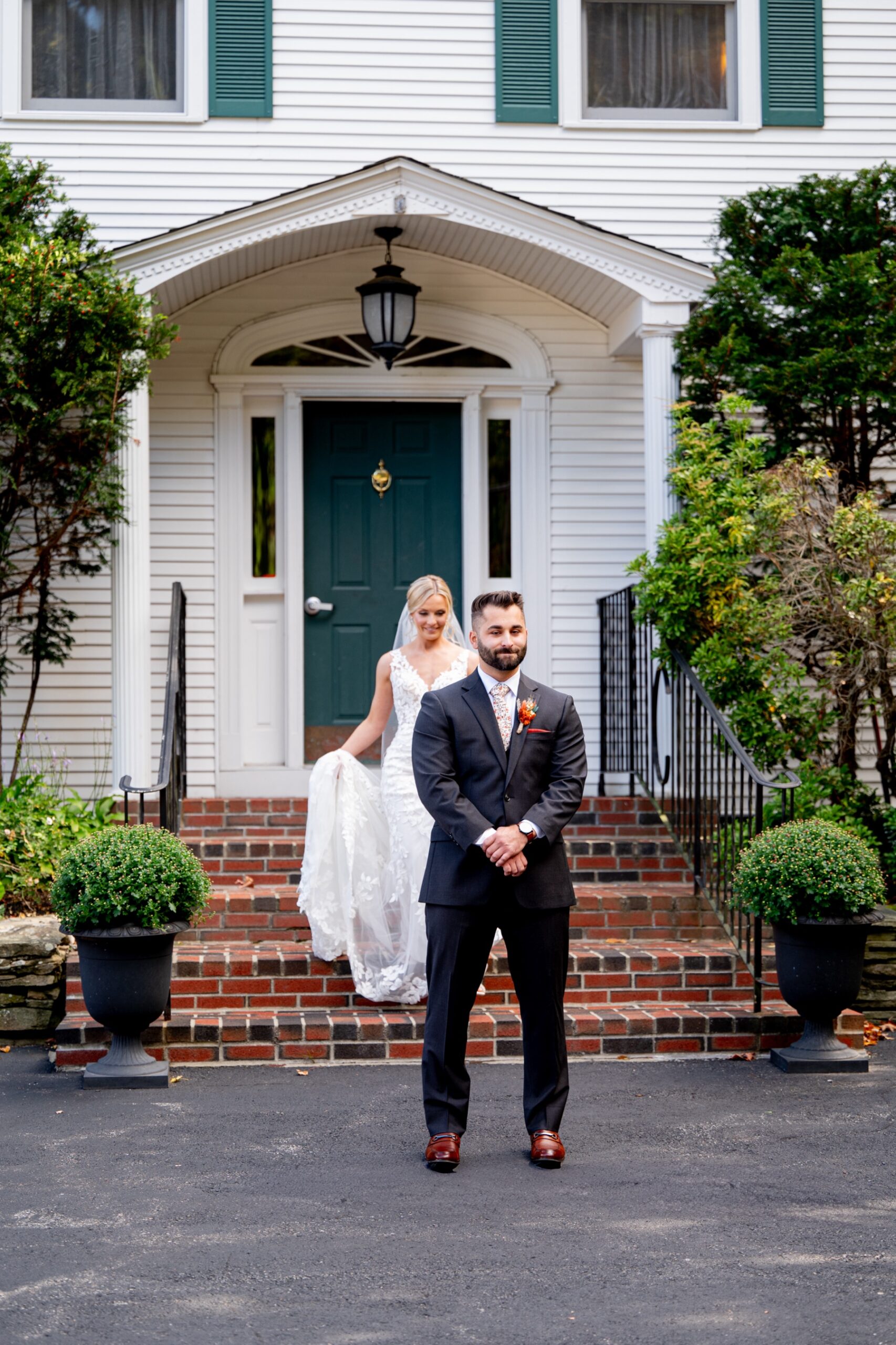 bride walking up behind the groom before their first look at the chocksett inn 