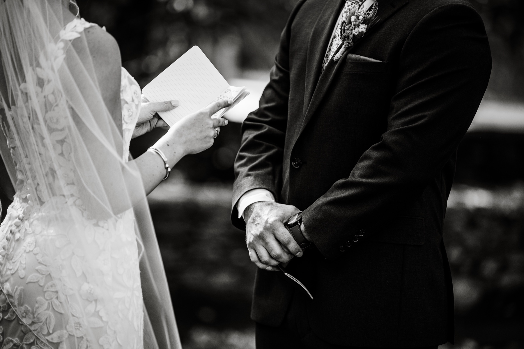 bride and groom reading vows to each other