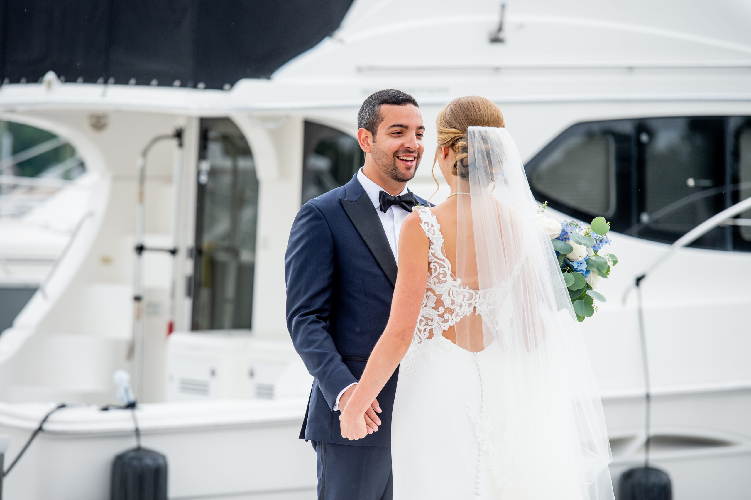 bride and groom smiling at each other during their first look